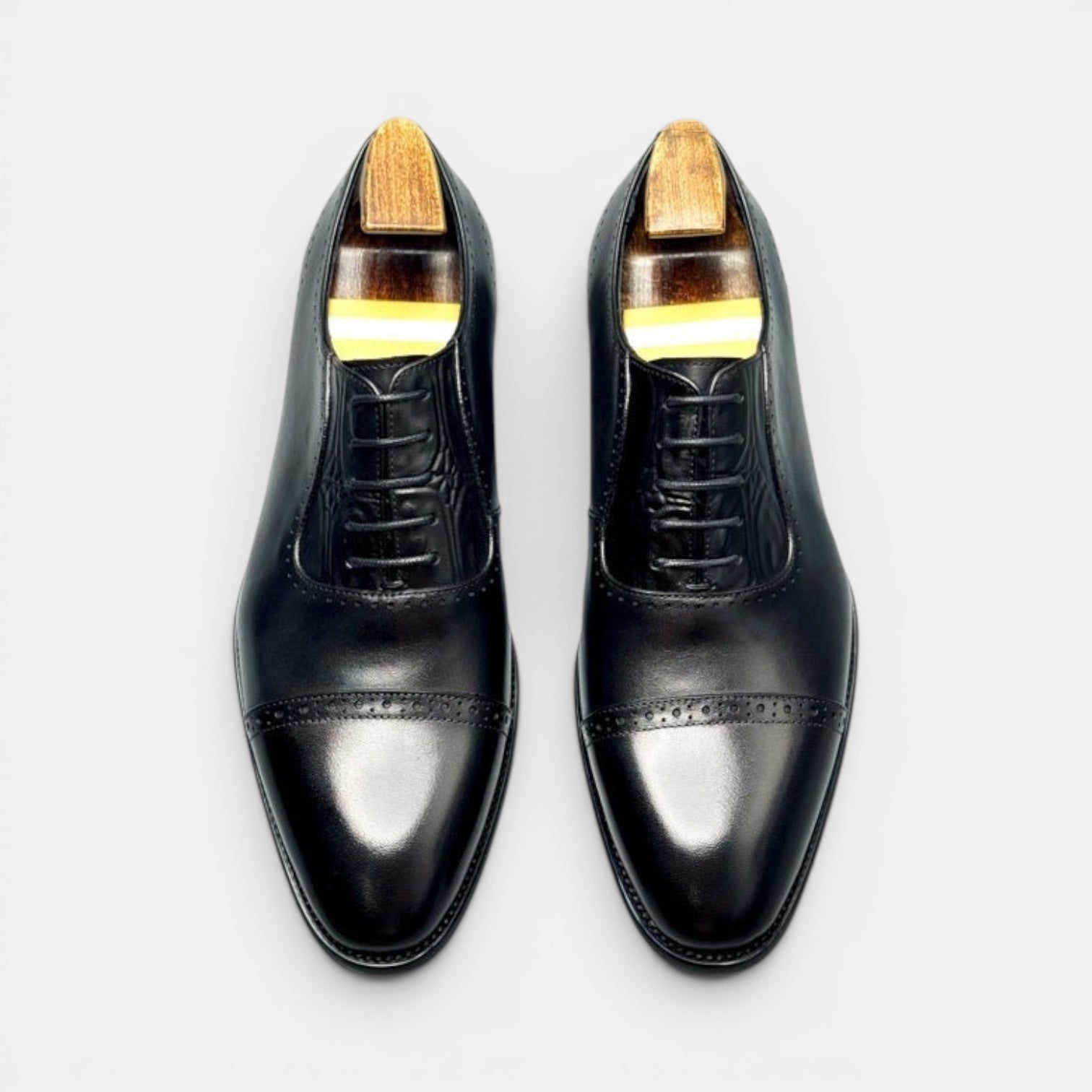 Barcon Getta Inc. BISSAU black full grain leather cap toe Oxford dress shoes with brogue perforations.