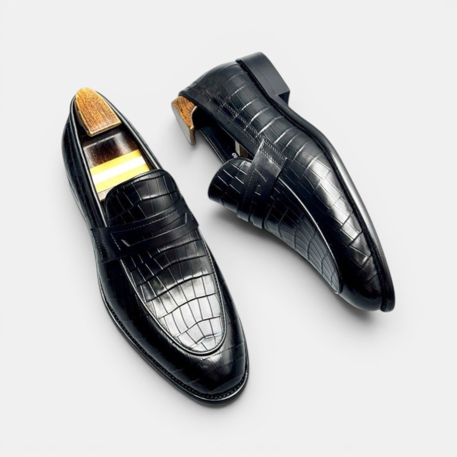 Barcon Getta Inc BRAZZAVILLE black leather crocodile-embossed penny loafers with wooden shoe trees.