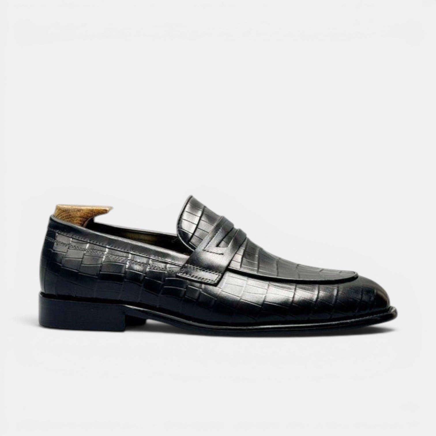 Barcon Getta Inc BRAZZAVILLE black leather crocodile-embossed penny loafers with a sleek silhouette.