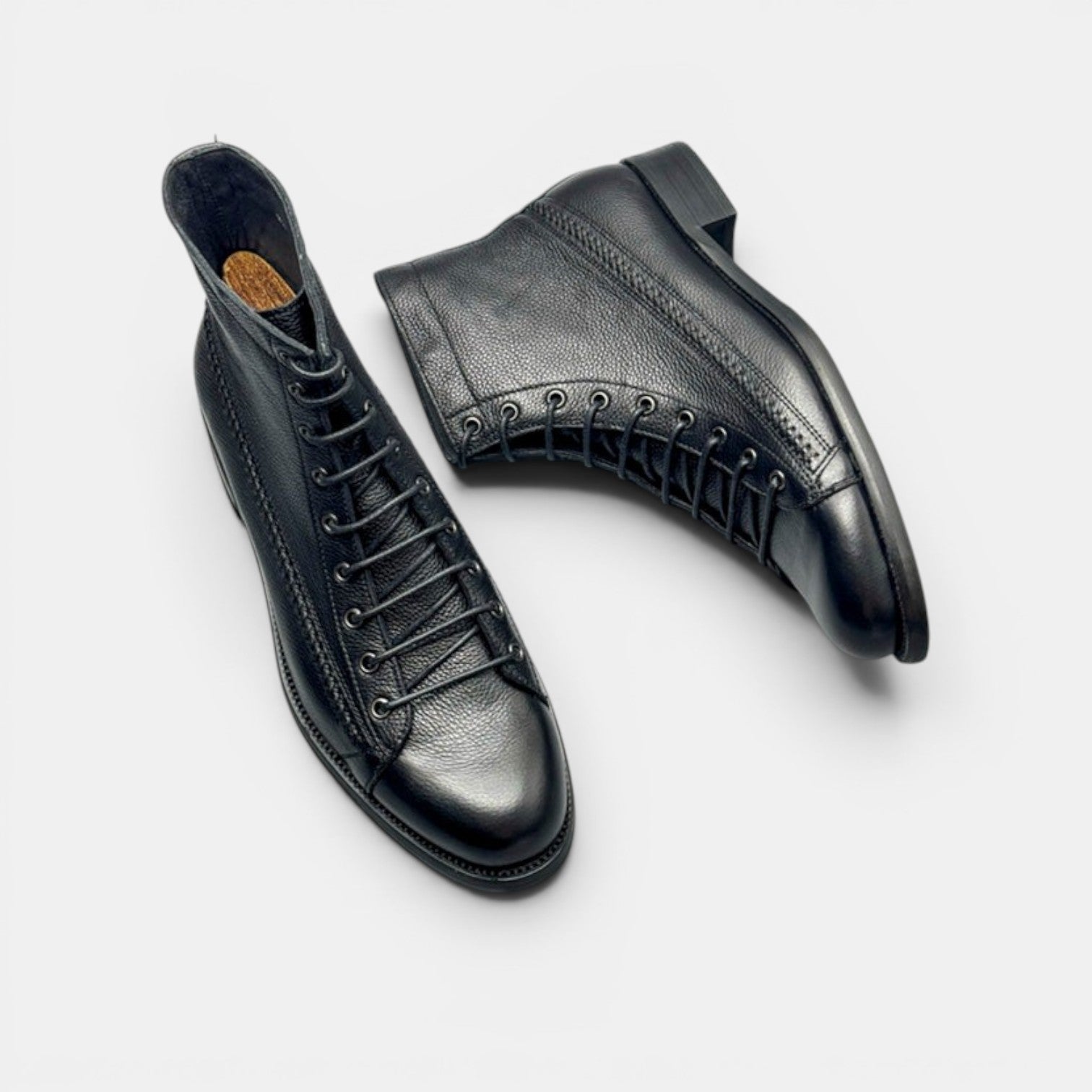 Barcon Getta Inc black leather lace-up ankle boots with textured finish and classic lacing.