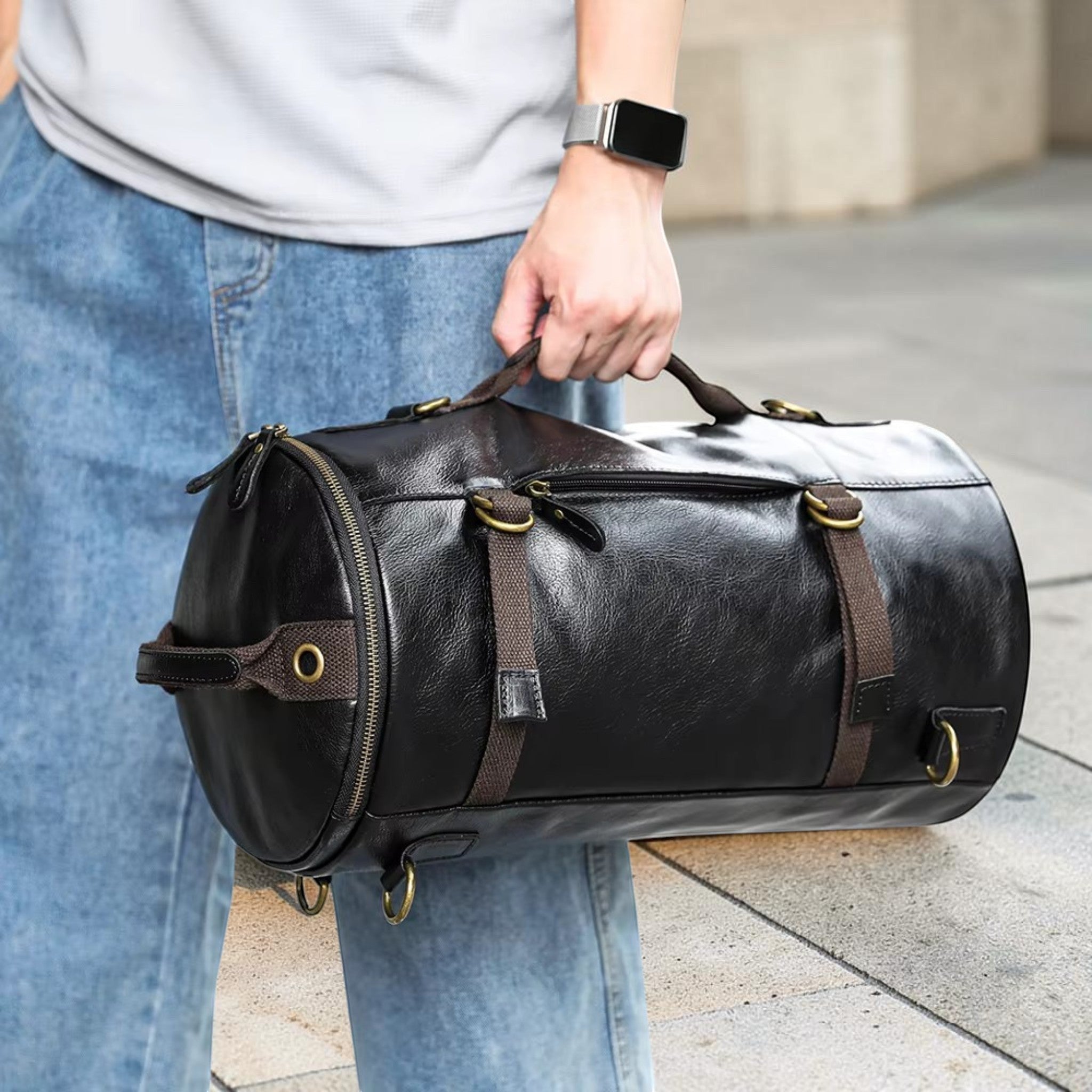 Barcon Getta Inc The Continental 2-1 Duffel, black distressed genuine leather cylindrical travel bag with brass hardware.