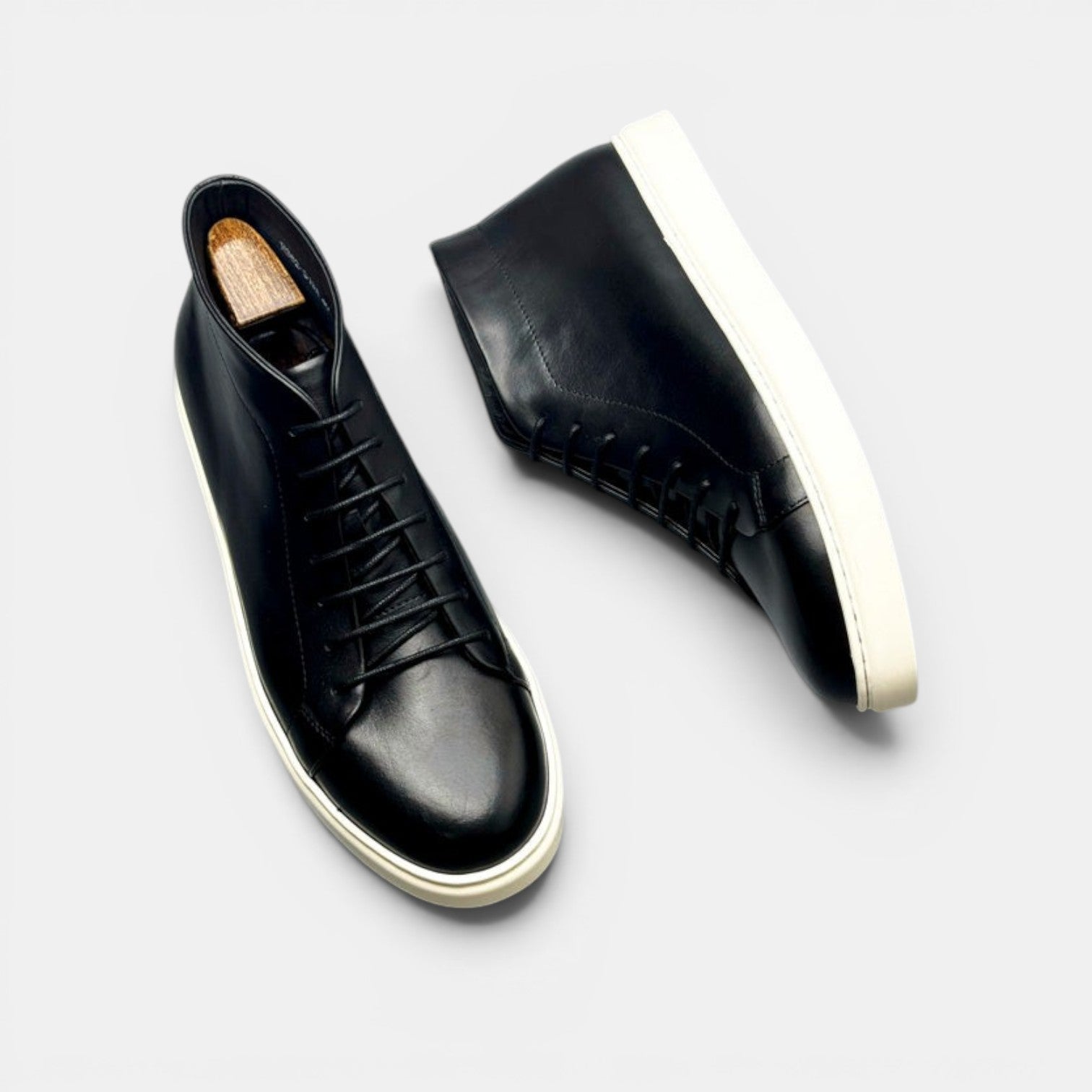 Barcon Getta Inc black leather high top sneakers with white rubber sole and lace-up closure.