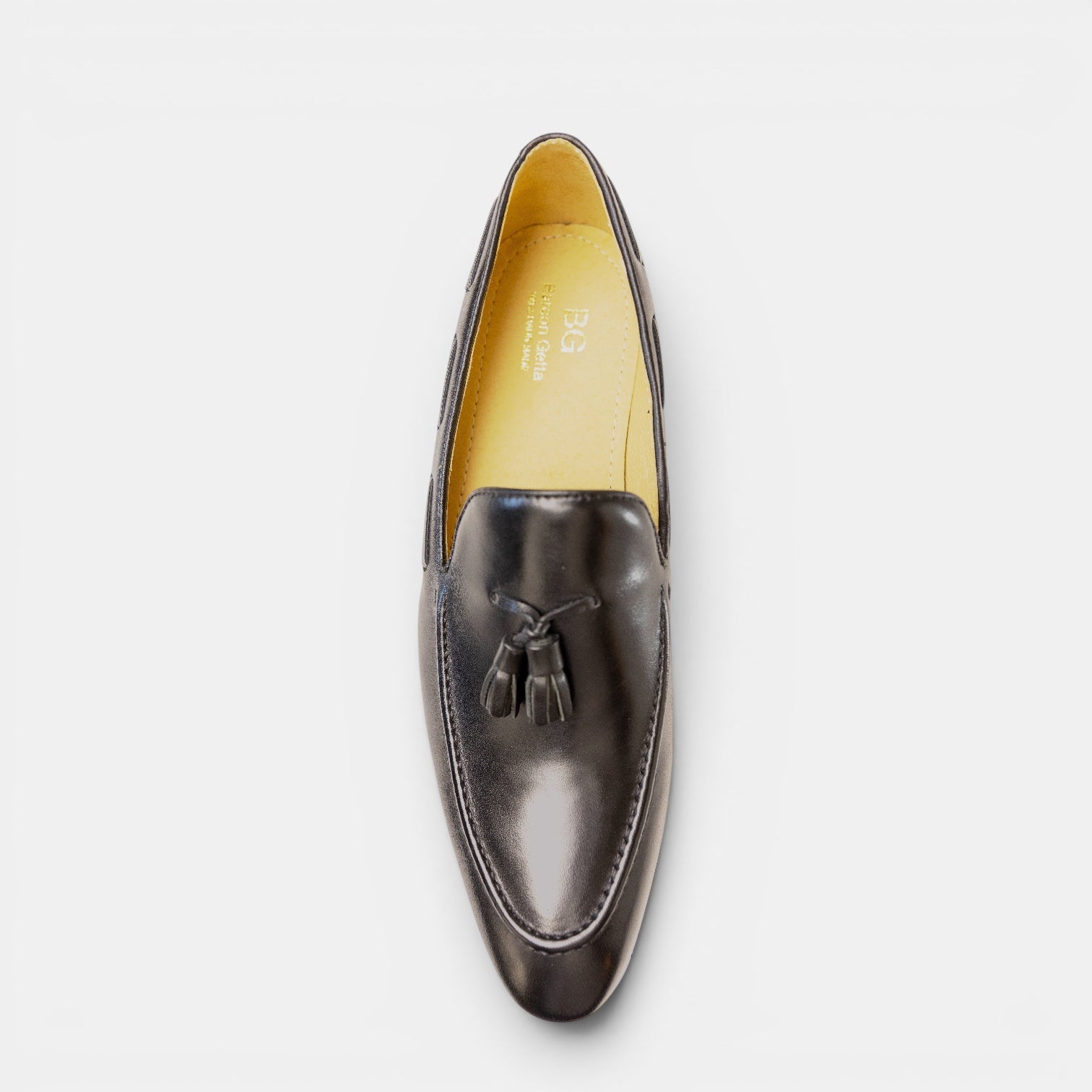 Barcon Getta Inc black full grain leather tassel loafer with a patent-like finish and amber lining.