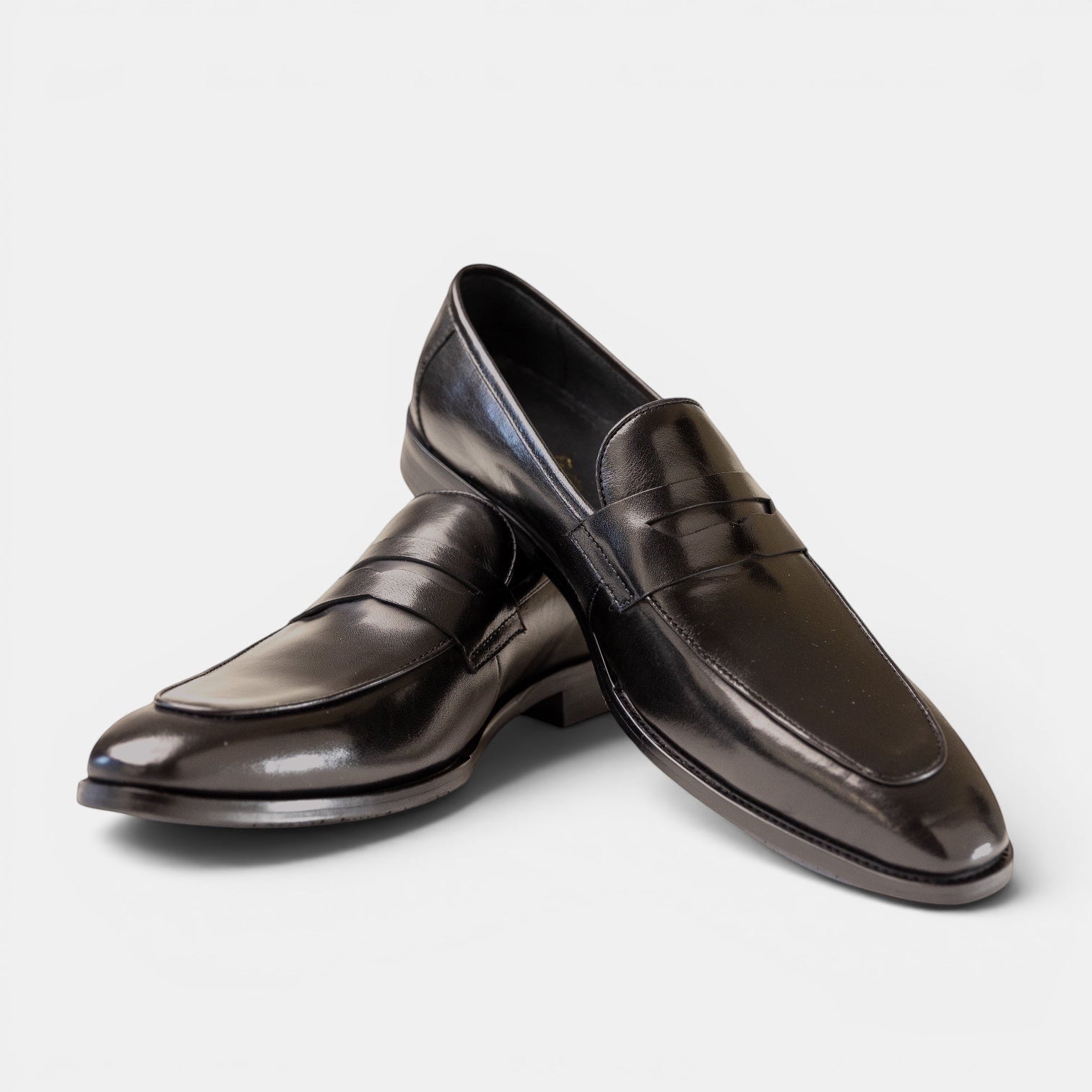 Barcon Getta Inc MONROVIA black leather penny loafers with a sleek silhouette and traditional strap.