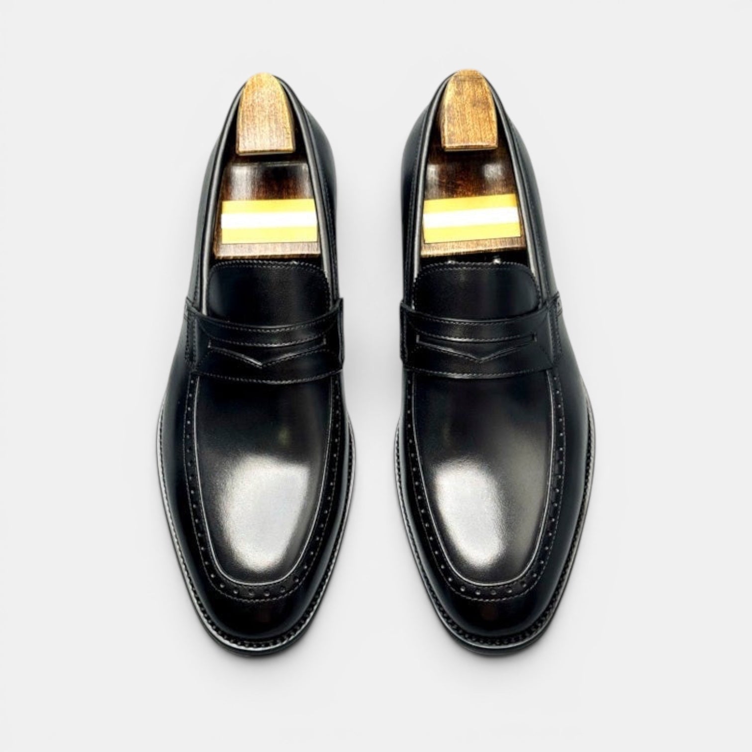 Barcon Getta Inc KINSHASA black leather penny loafers with subtle stitching details and refined silhouette.