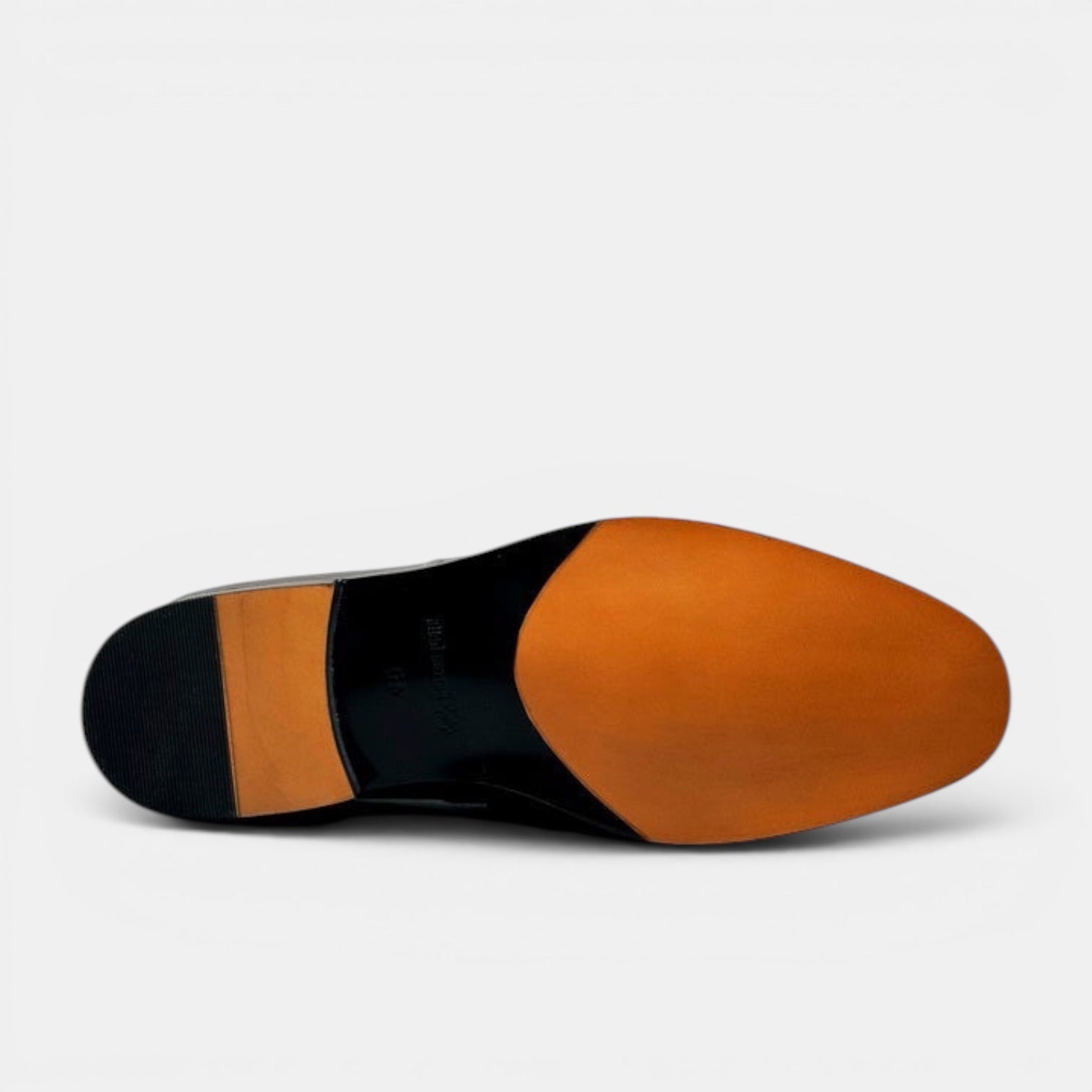 Barcon Getta Inc KINSHASA black leather penny loafers, view of the sole with tan leather and black rubber heel.