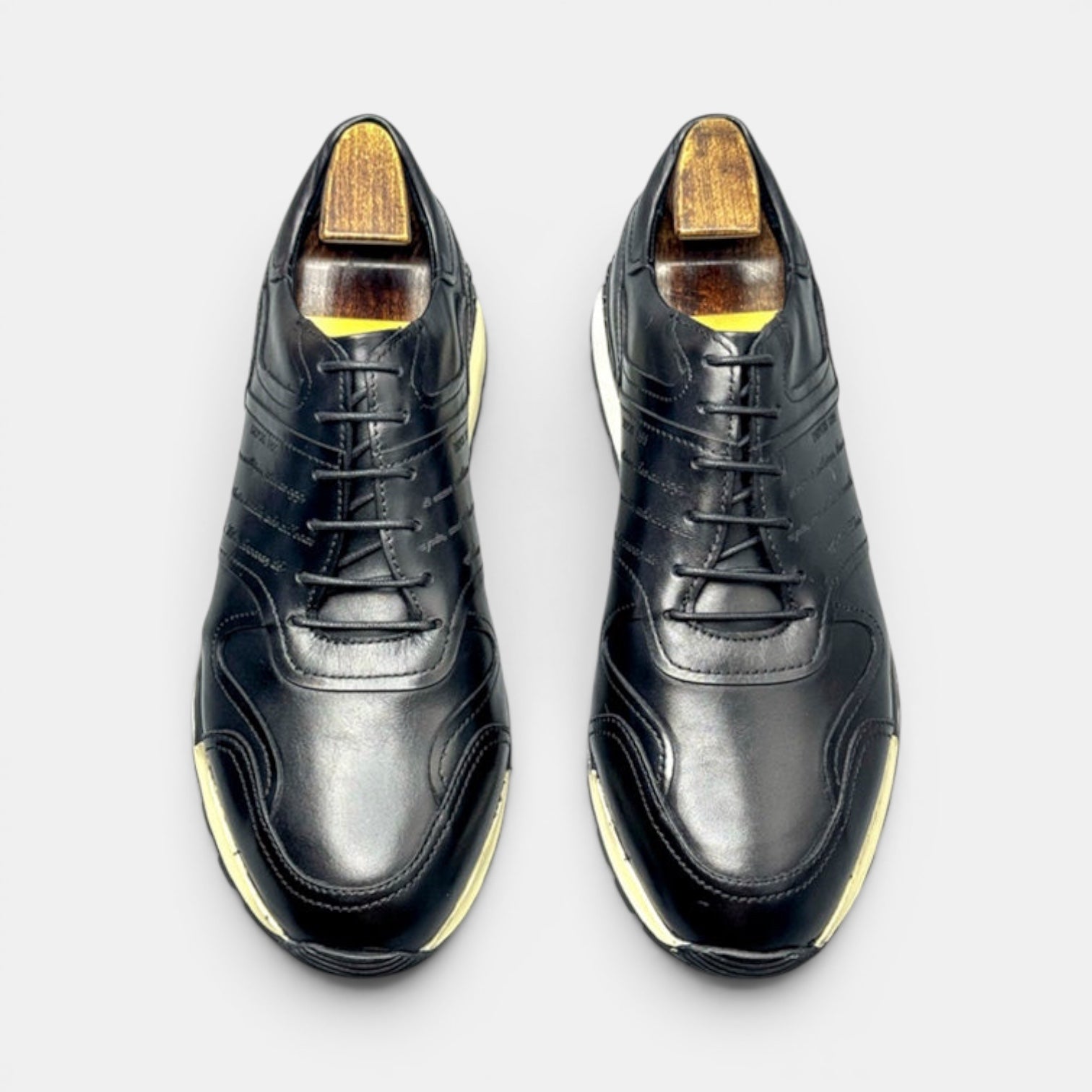 Barcon Getta Inc black leather FREETOWN casual sneakers with cap toe and white midsole stripe.
