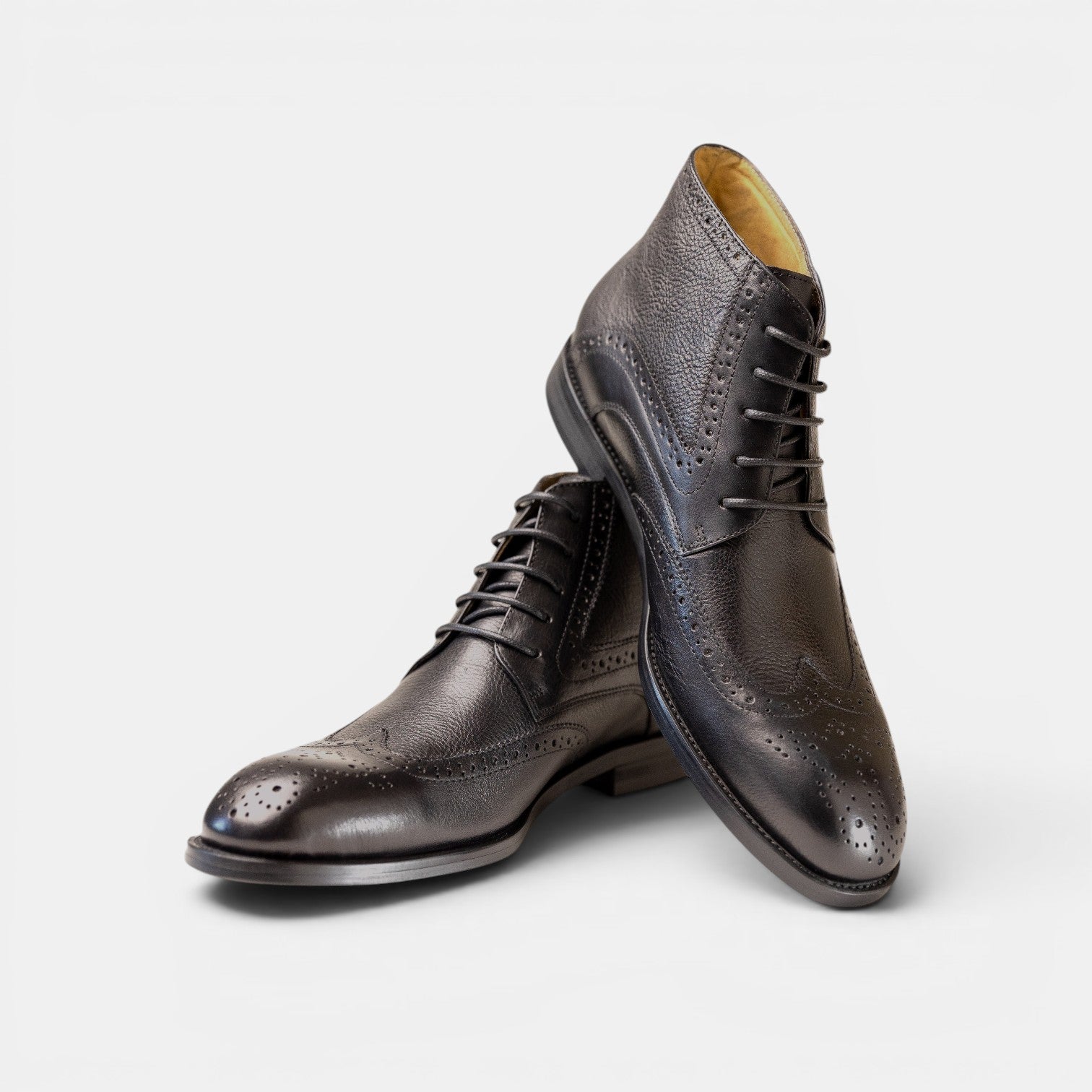 Barcon Getta Inc black textured leather wingtip lace-up boots with brogue detailing.