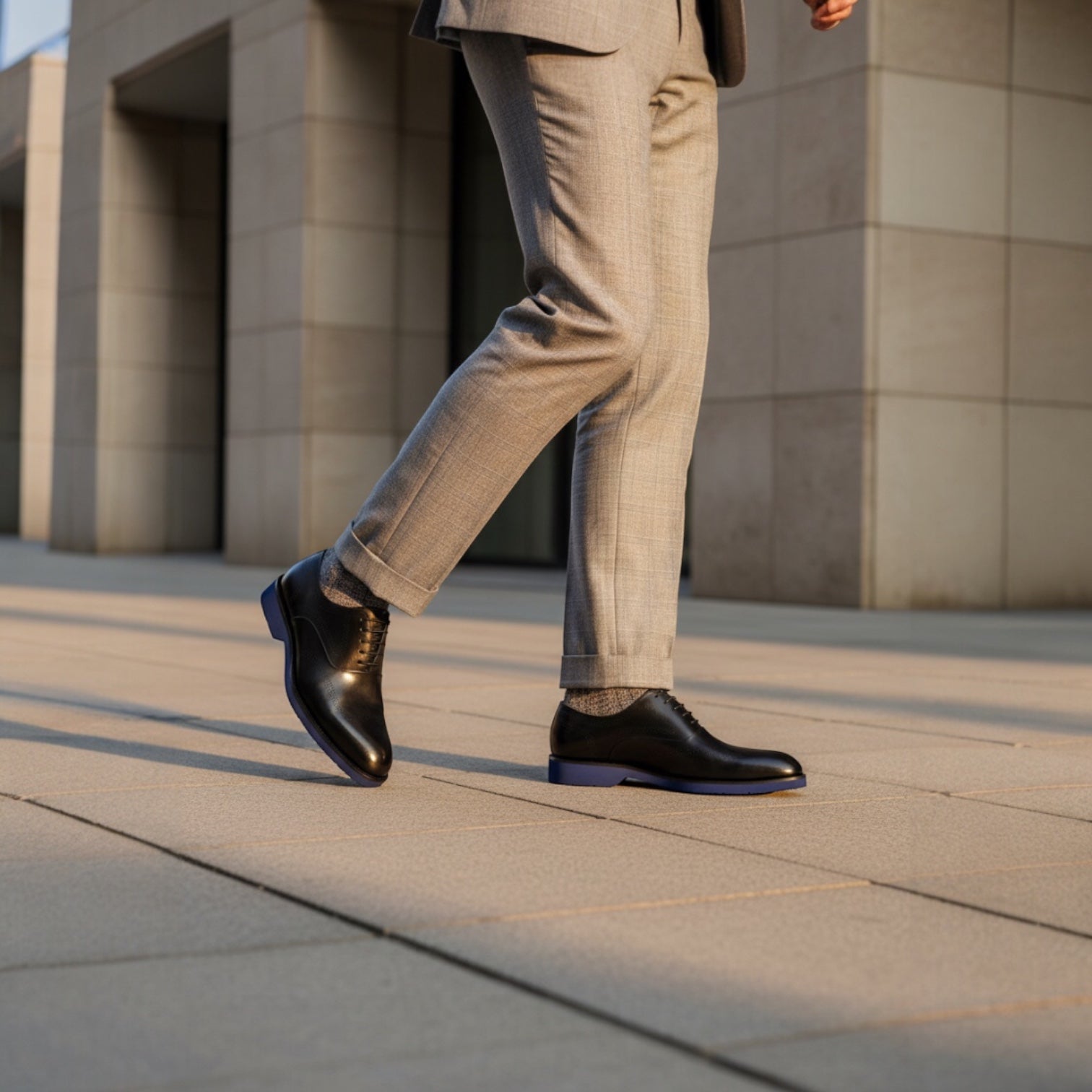 Barcon Getta Inc black leather wingtip Oxford dress shoes with navy blue soles and brogue detailing.