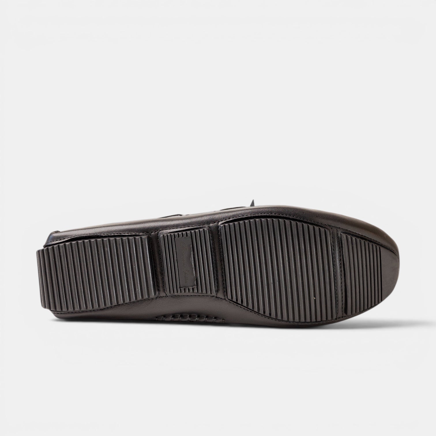 Barcon Getta Inc black woven leather driving moccasins with rubber sole and ribbed tread.