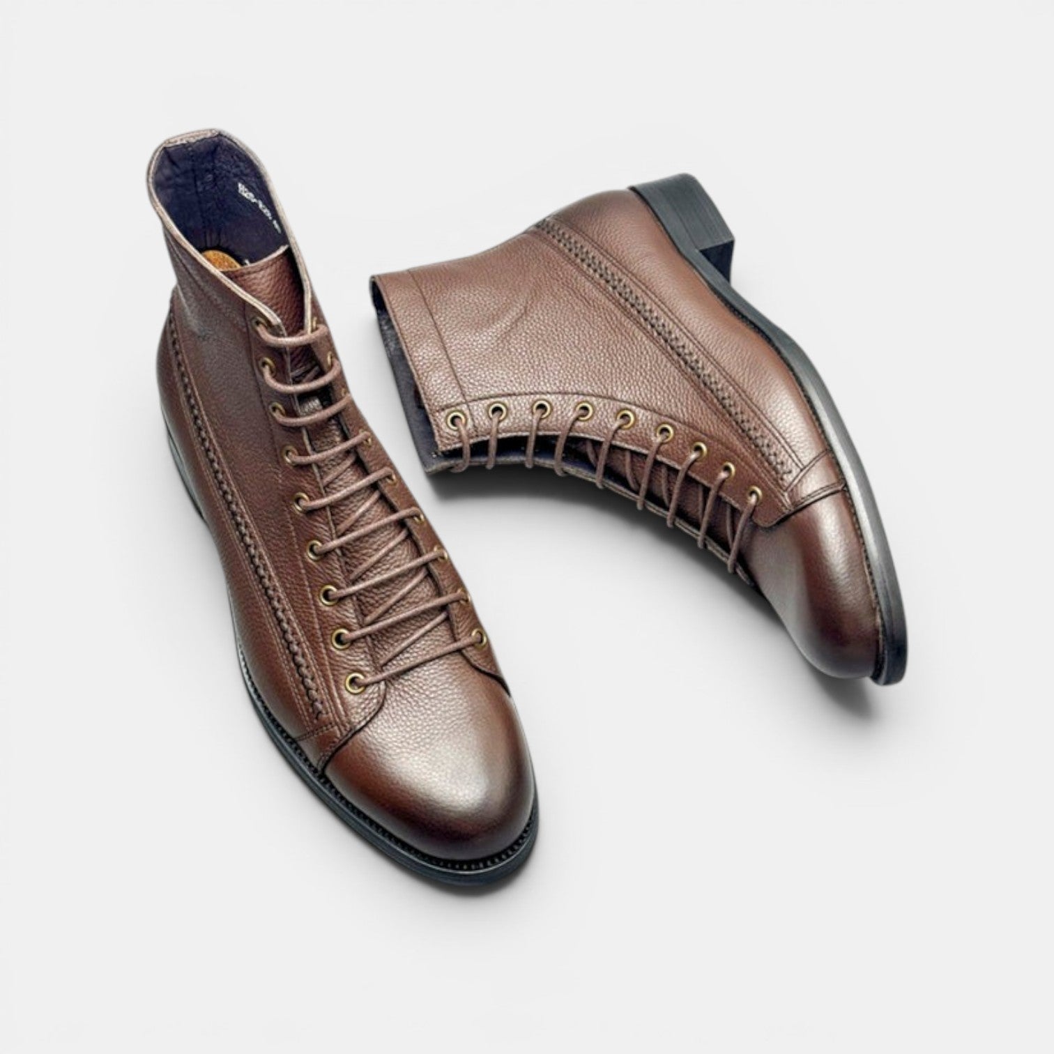 Barcon Getta Inc brown leather lace-up ankle boots with textured finish and brass eyelets.