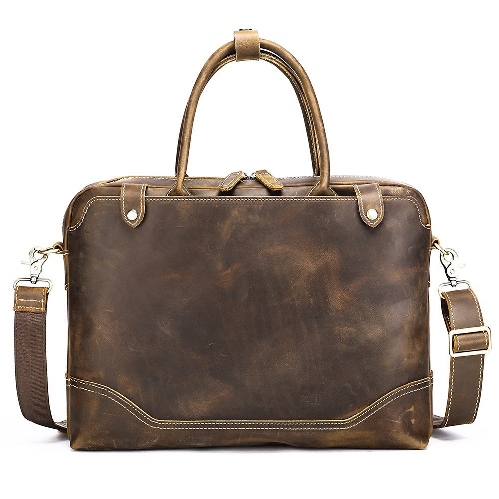 Barcon Getta Inc The Deal Maker brown distressed leather briefcase with top handles and detachable shoulder strap.