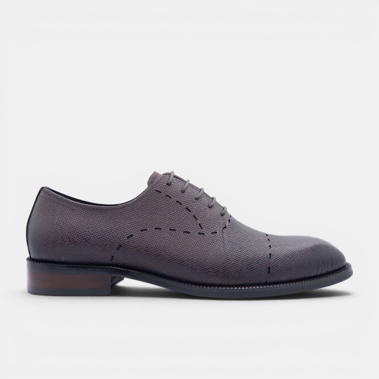 Barcon Getta Inc charcoal grey Saffiano embossed leather Oxford dress shoe with decorative stitching and red sole detail.