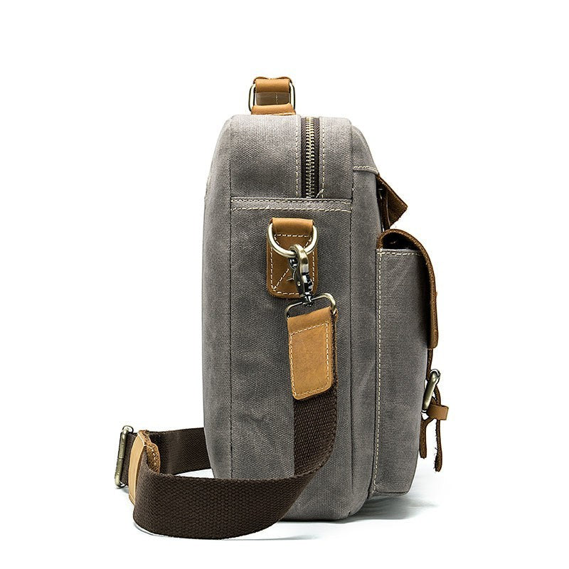 Barcon Getta Inc THE CLASSIC grey canvas messenger bag with tan leather accents and buckle pockets.