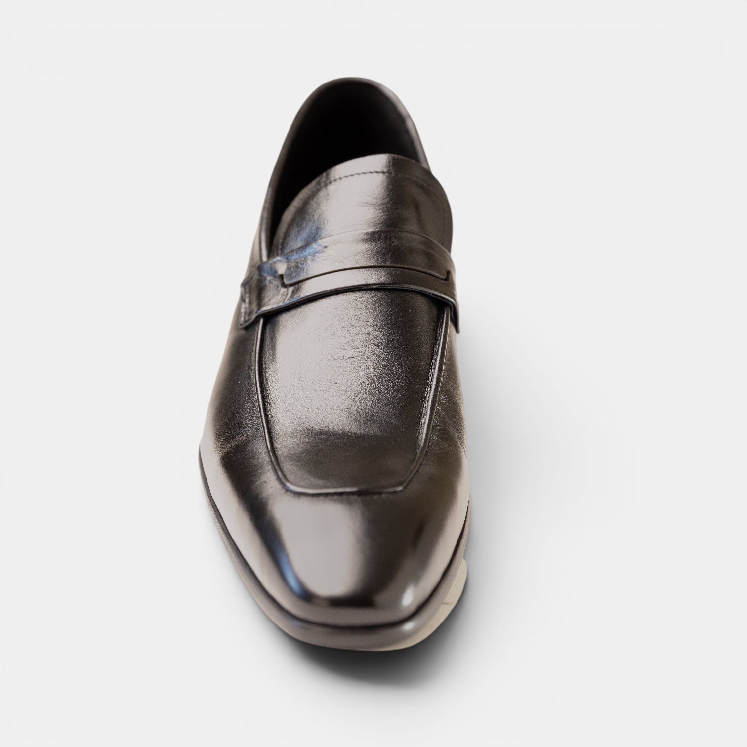Barcon Getta Inc CONAKRY black high-polish full-grain leather penny loafer with smooth upper and hybrid sole.