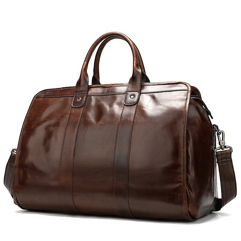 Brown leather duffel bag on a white background