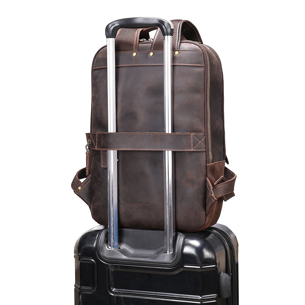 Barcon Getta Inc dark brown distressed genuine leather backpack with trolley strap and multiple pockets.