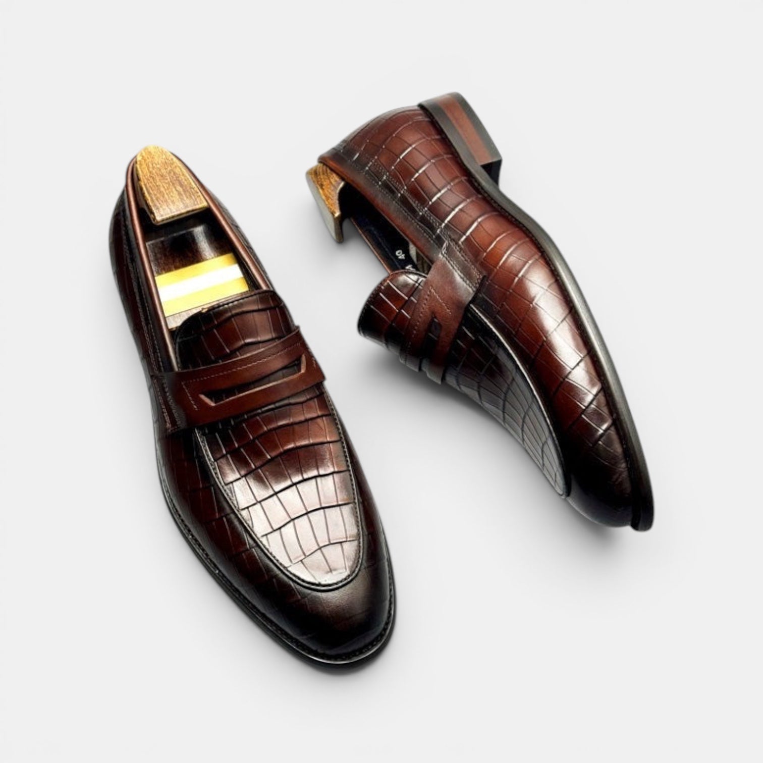 Barcon Getta Inc BRAZZAVILLE men's dark brown crocodile-embossed leather penny loafers with a sleek silhouette.