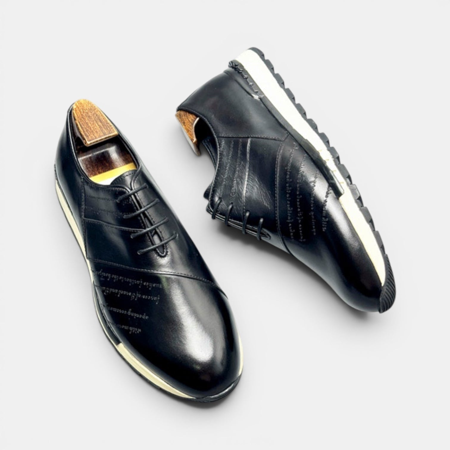 Barcon Getta Inc FREETOWN SHARP black full grain leather plain toe sneakers with embossed script and lug sole.