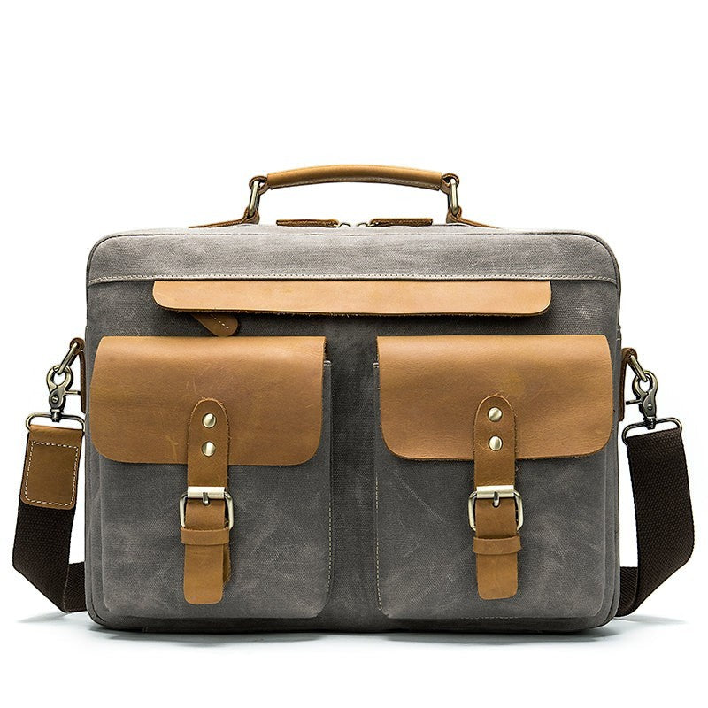 Barcon Getta Inc THE CLASSIC grey canvas messenger bag with tan leather accents, buckle pockets, and top handle.