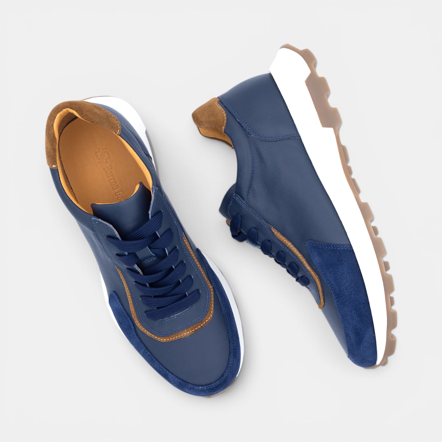 Barcon Getta Inc GUYA sneakers in dark navy leather with white and tan accents, gum sole.