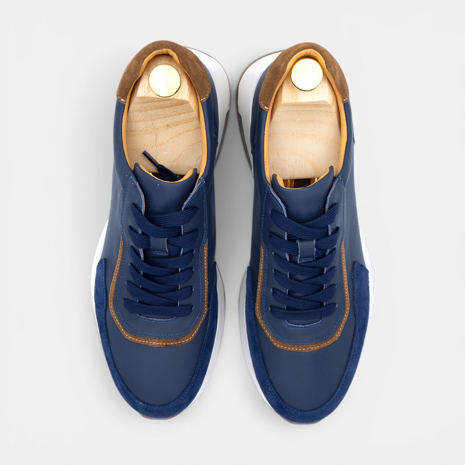 Barcon Getta Inc GUYA sneakers in dark navy leather with white panels and tan heel accent. Lace-up closure.