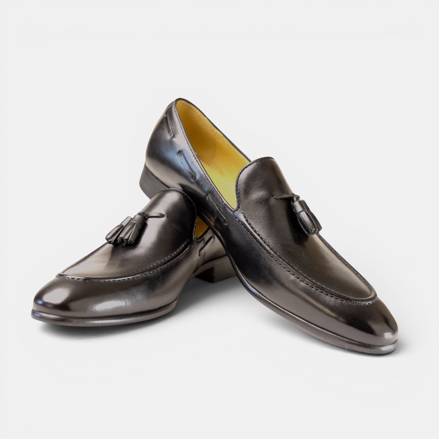 Barcon Getta Inc Kampala tassel loafers in deep navy/aubergine full-grain leather with a patent-like finish and amber lining.