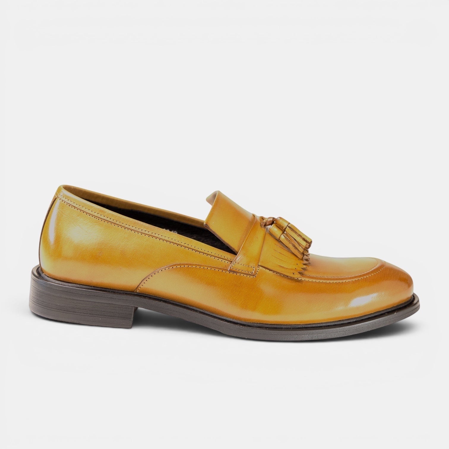 Barcon Getta Inc KUMASSI mustard yellow full-grain leather tassel loafer with apron toe and mirror-polished finish.