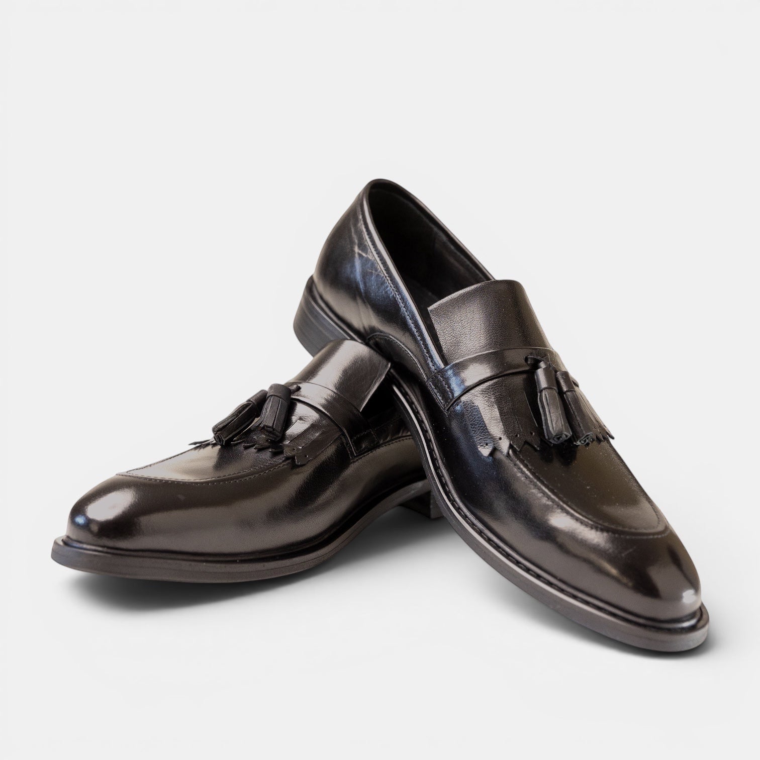 Barcon Getta Inc KUMASSI espresso brown full-grain leather tassel loafers with a high-gloss mirror finish and apron toe.