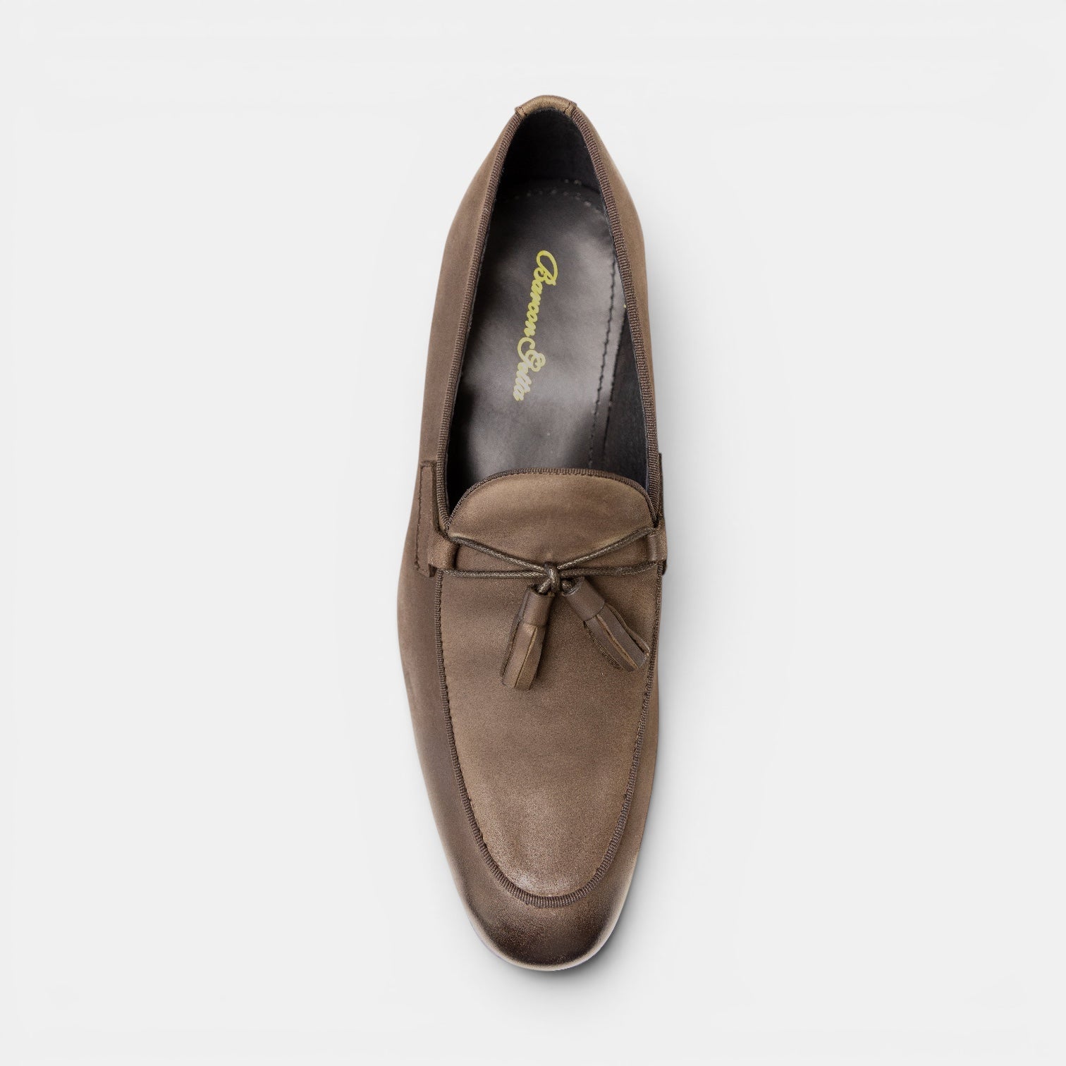 Barcon Getta Inc MANZINI taupe full-grain leather tassel loafer with apron toe and matte burnished finish.