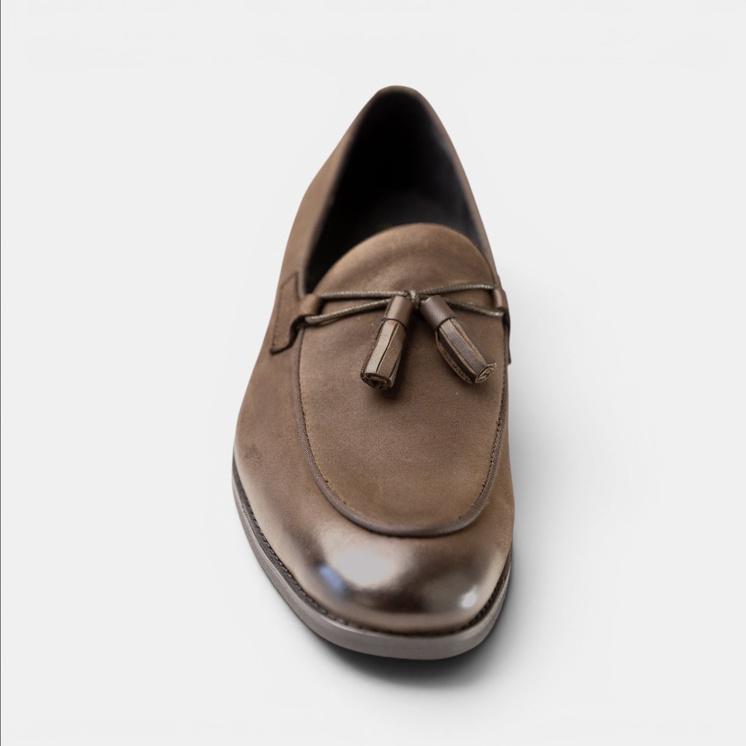 Barcon Getta Inc MANZINI taupe full-grain leather tassel loafer with apron toe and matte-burnished finish.