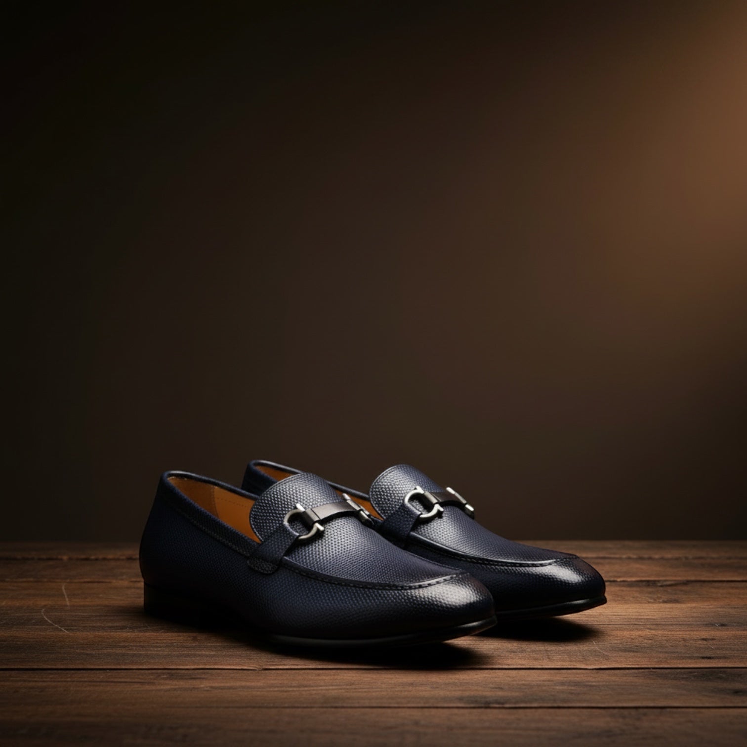 Barcon Getta Inc NAMPULA navy blue textured leather horsebit loafers with gunmetal hardware.