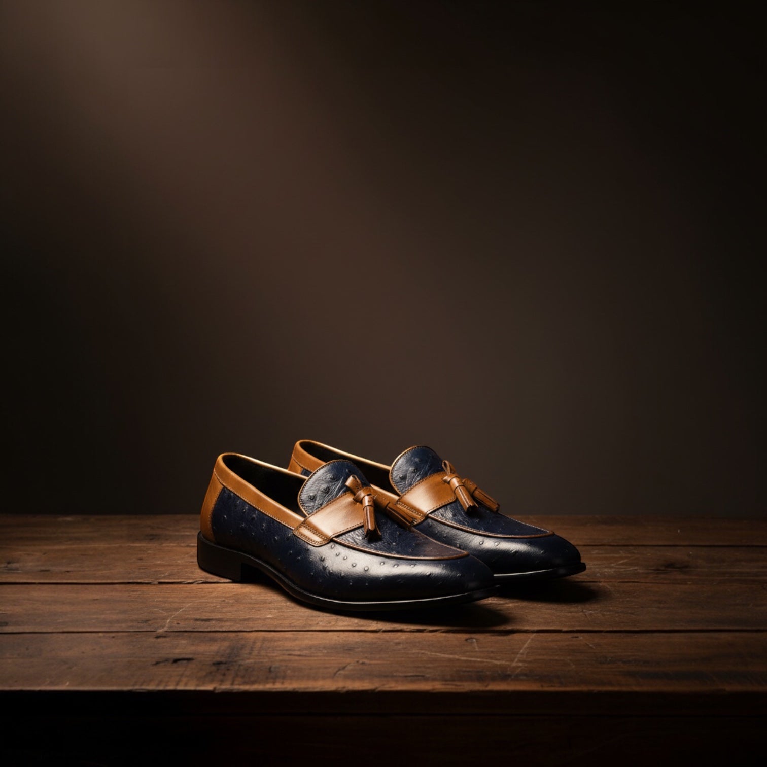 Barcon Getta Inc navy blue ostrich embossed leather loafers with tan trim and tassels. Low stacked heel.
