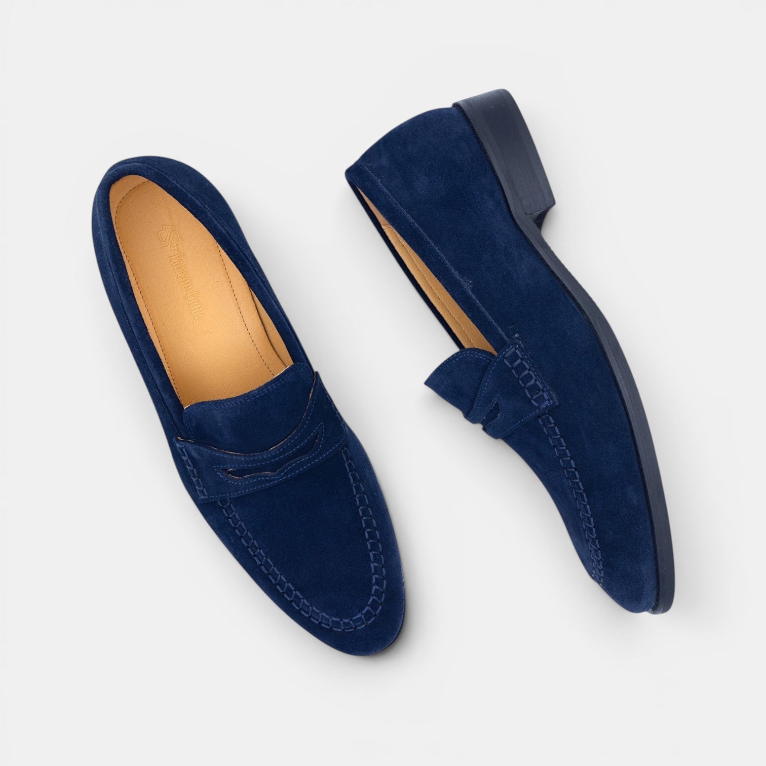 Barcon Getta Inc navy blue suede penny loafers with hand-stitched moccasin toe and tan leather insole.