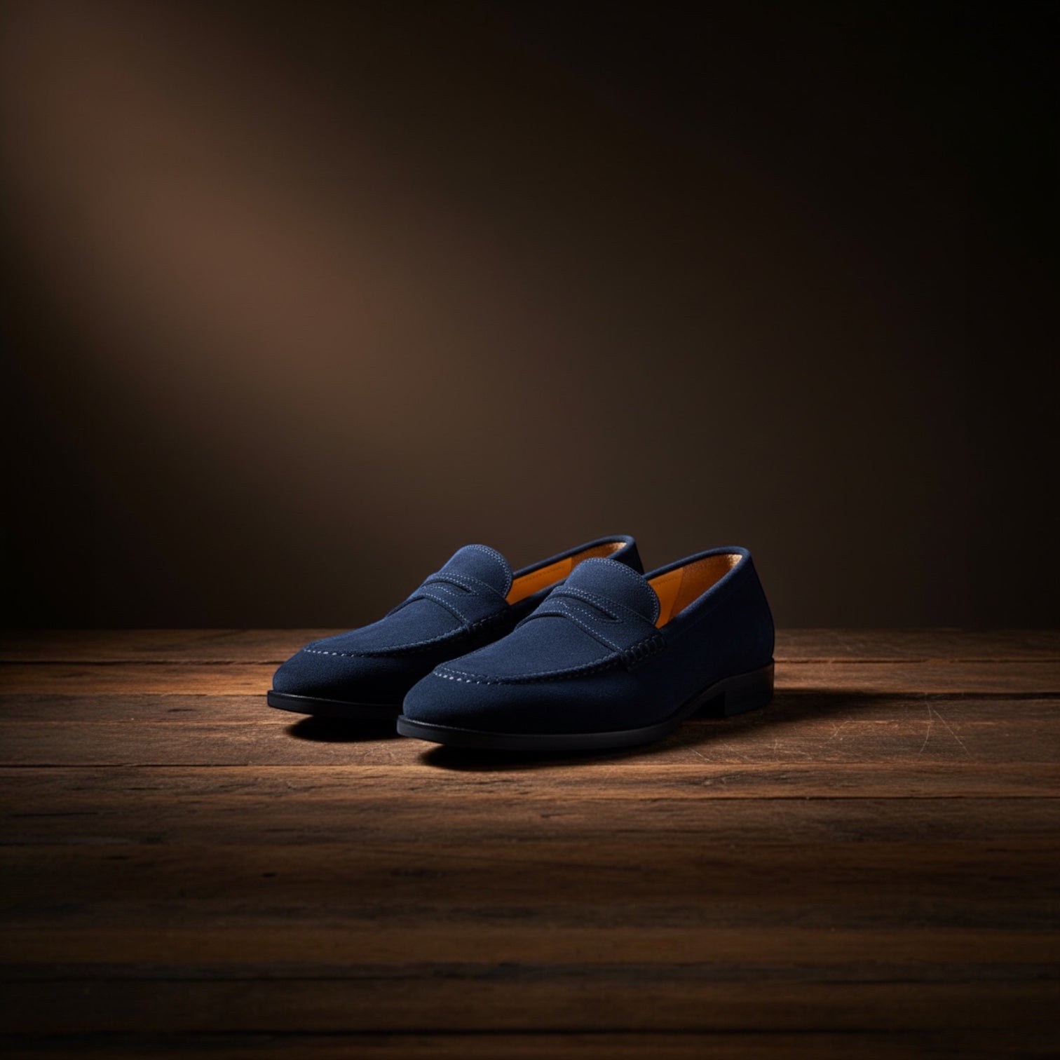 Barcon Getta Inc navy suede penny loafers with hand-stitched moccasin toe and tan leather insole.