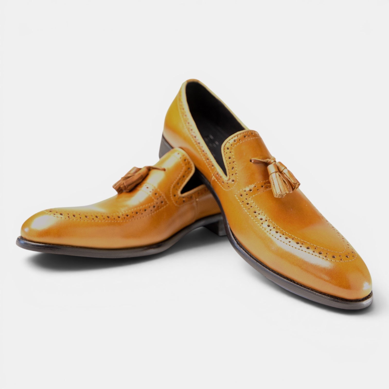 Barcon Getta Inc NEGA tassel loafers in warm tan full-grain leather with full brogue detailing and a polished finish.
