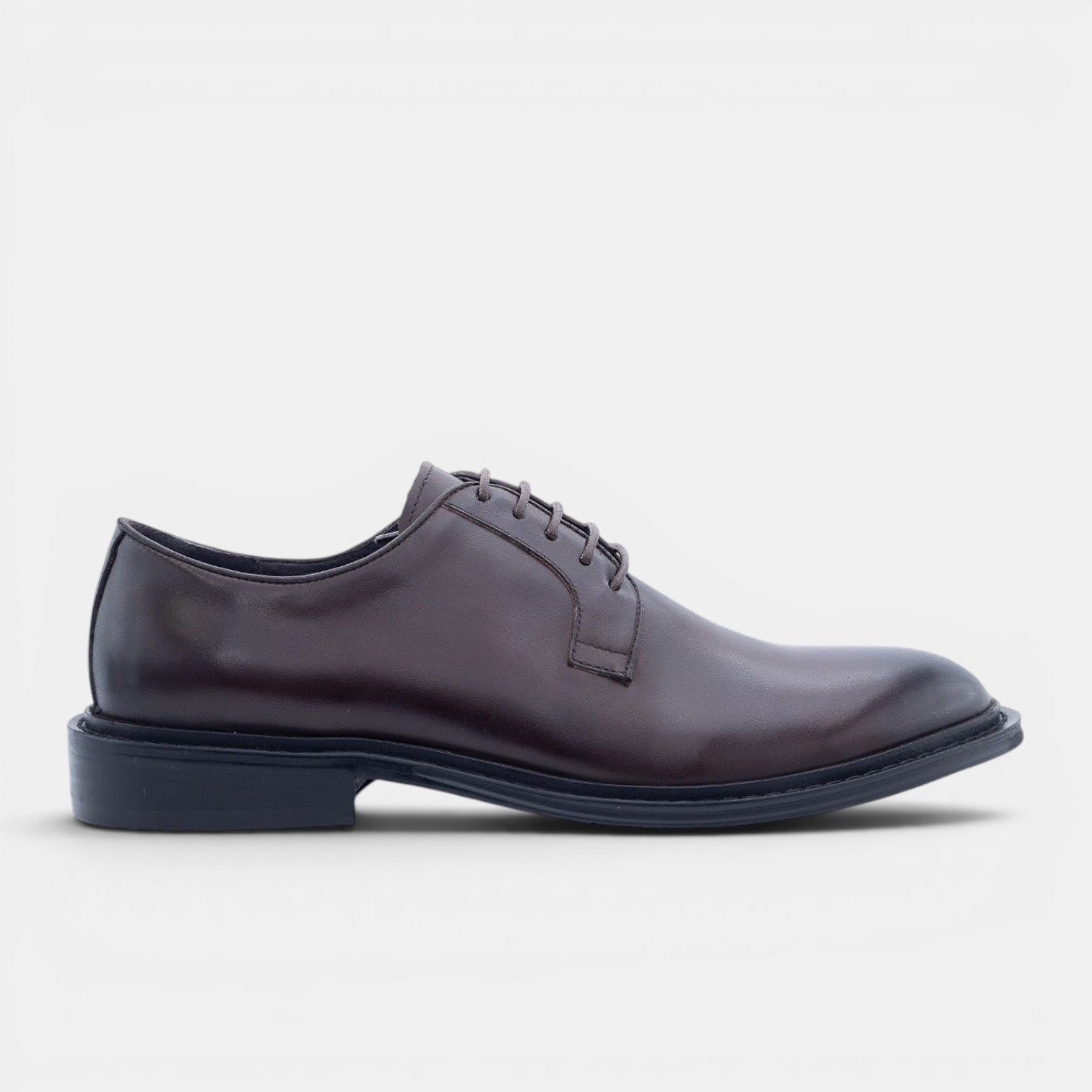 Barcon Getta Inc NYOTA plain toe Derby shoes in dark espresso brown hand-burnished full grain leather with a navy rubber sole.