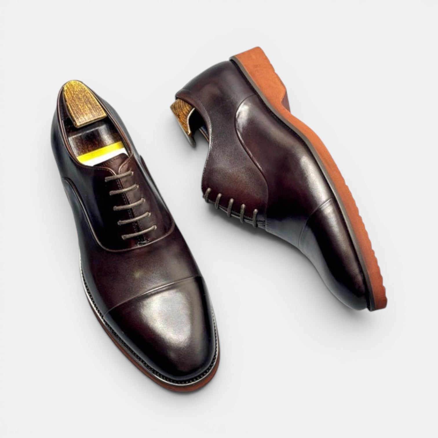 Barcon Getta Inc SAO TOME oxblood brown cap toe Oxford dress shoes made of full grain leather with a burnt orange sole.