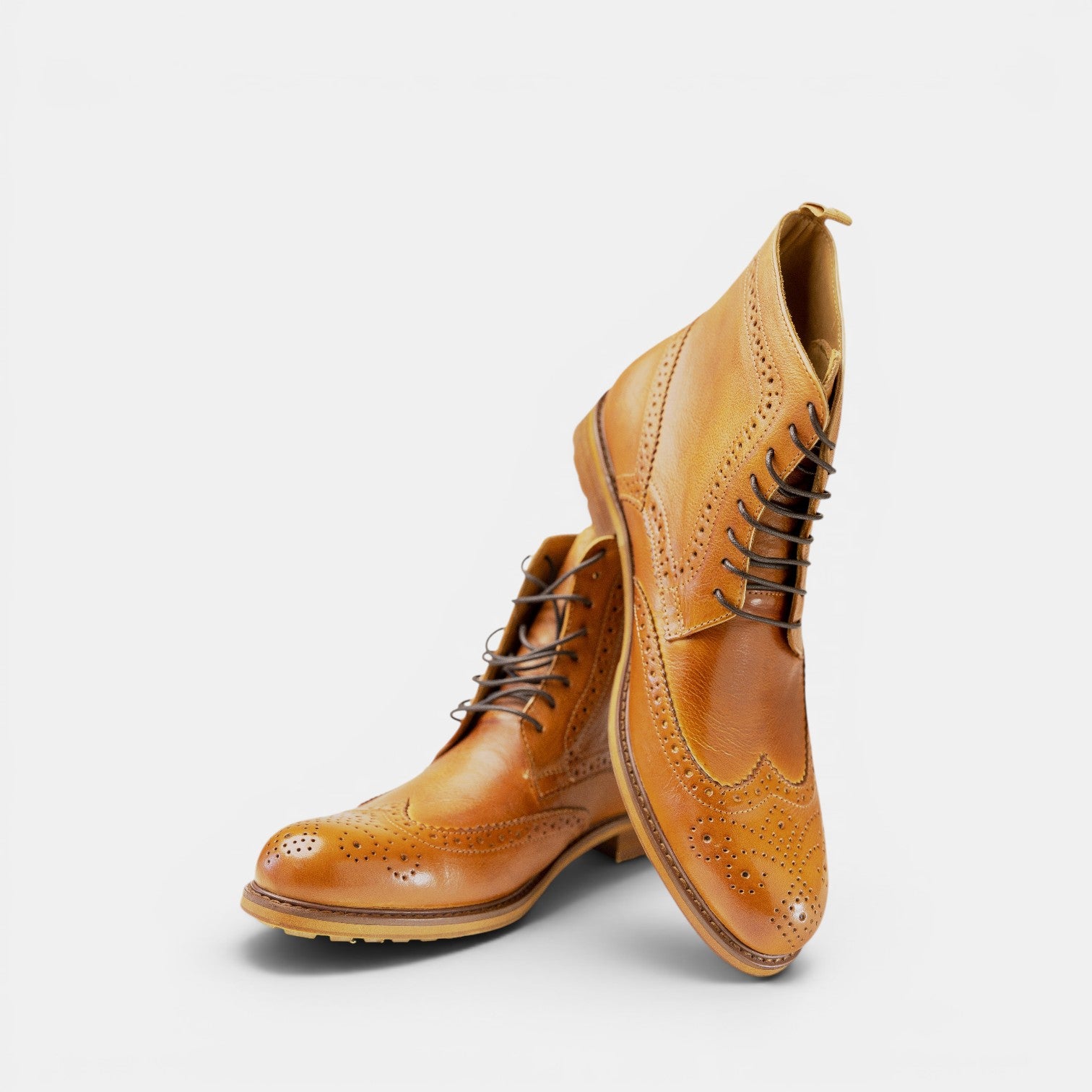 Barcon Getta Inc tan leather wingtip lace-up boots with brogue detailing and durable sole.