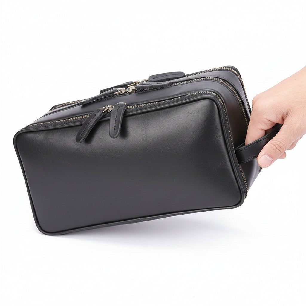 Barcon Getta Inc brown leather travel kit with multiple zippered compartments and a side handle.