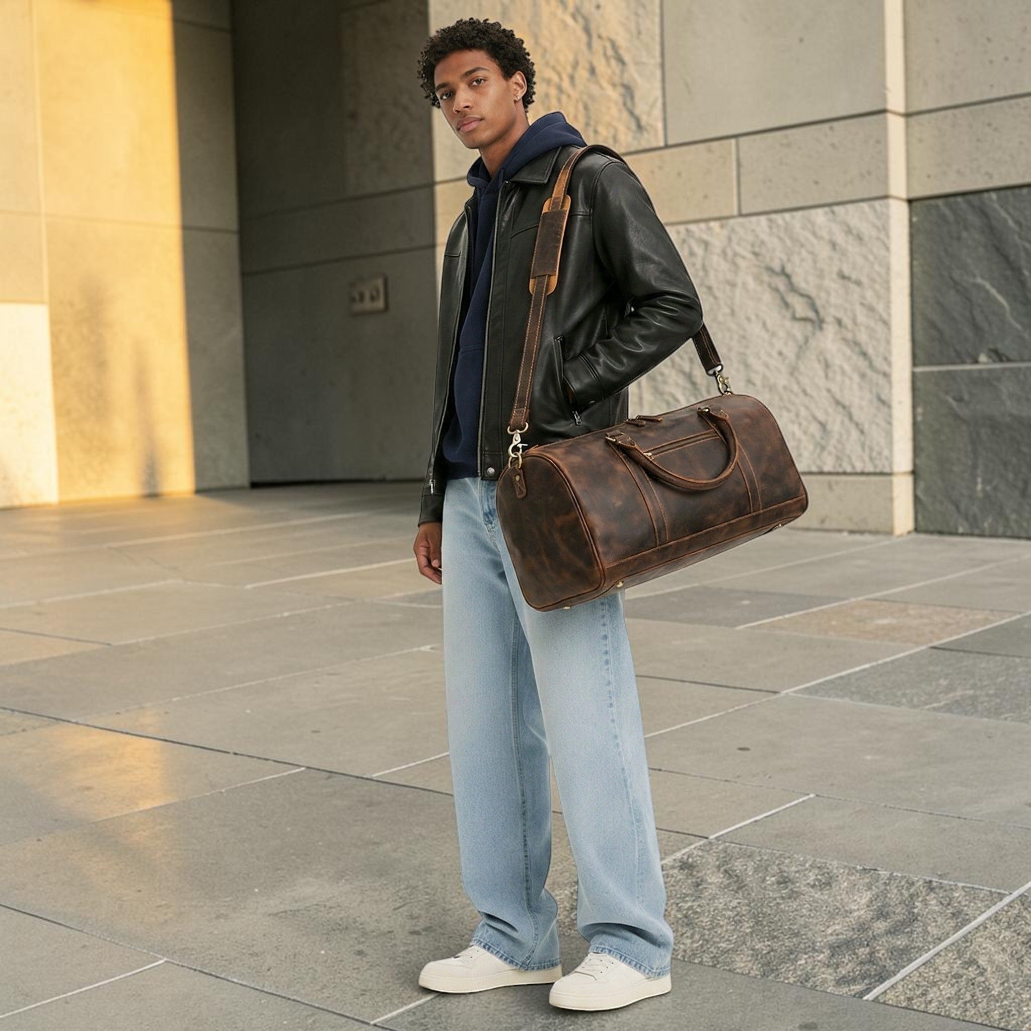 Barcon Getta Inc distressed brown leather duffel bag with top handles and adjustable shoulder strap.