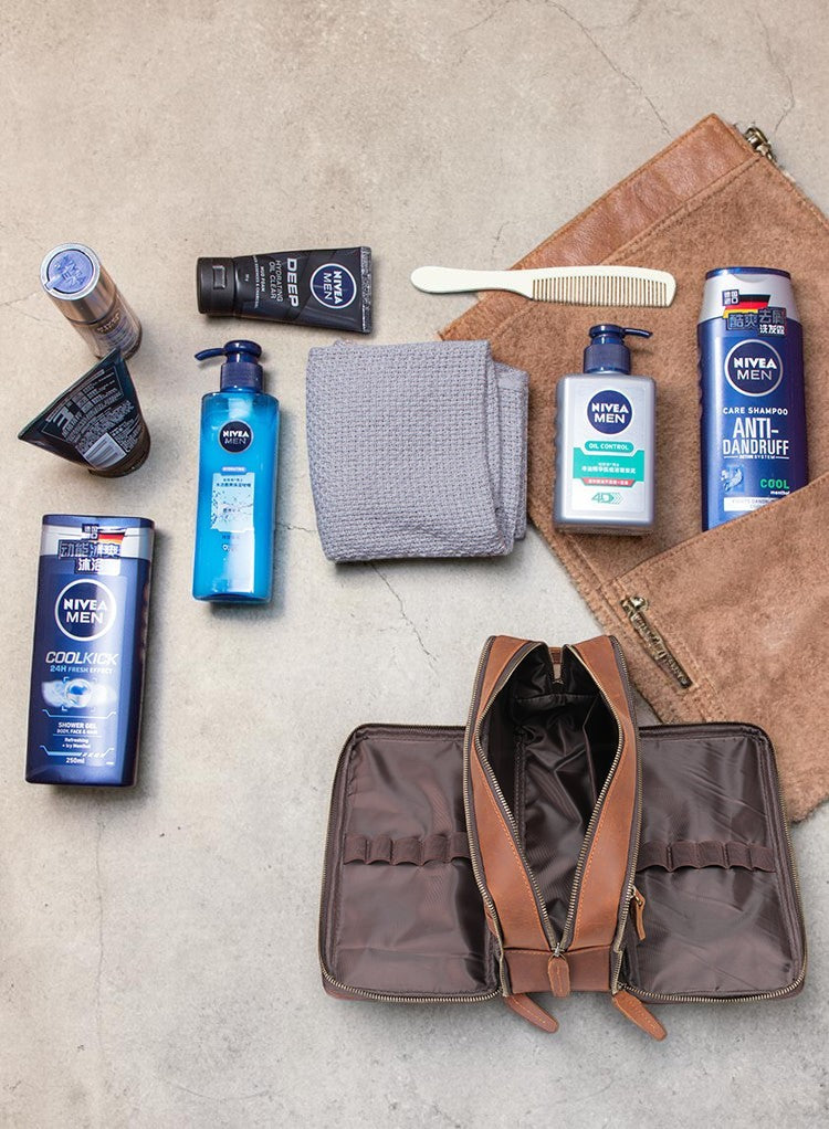 Barcon Getta Inc brown leather travel kit with Nivea Men toiletries, comb, and grey towel.