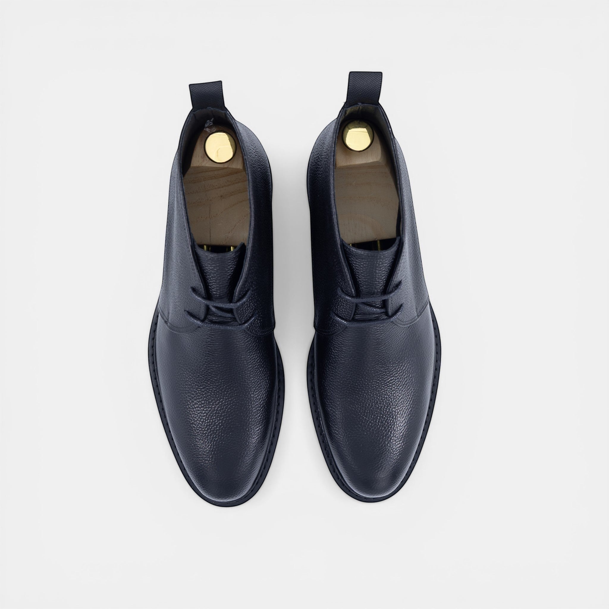 Barcon Getta Inc black textured leather chukka boots with lace-up closure and durable lug sole.