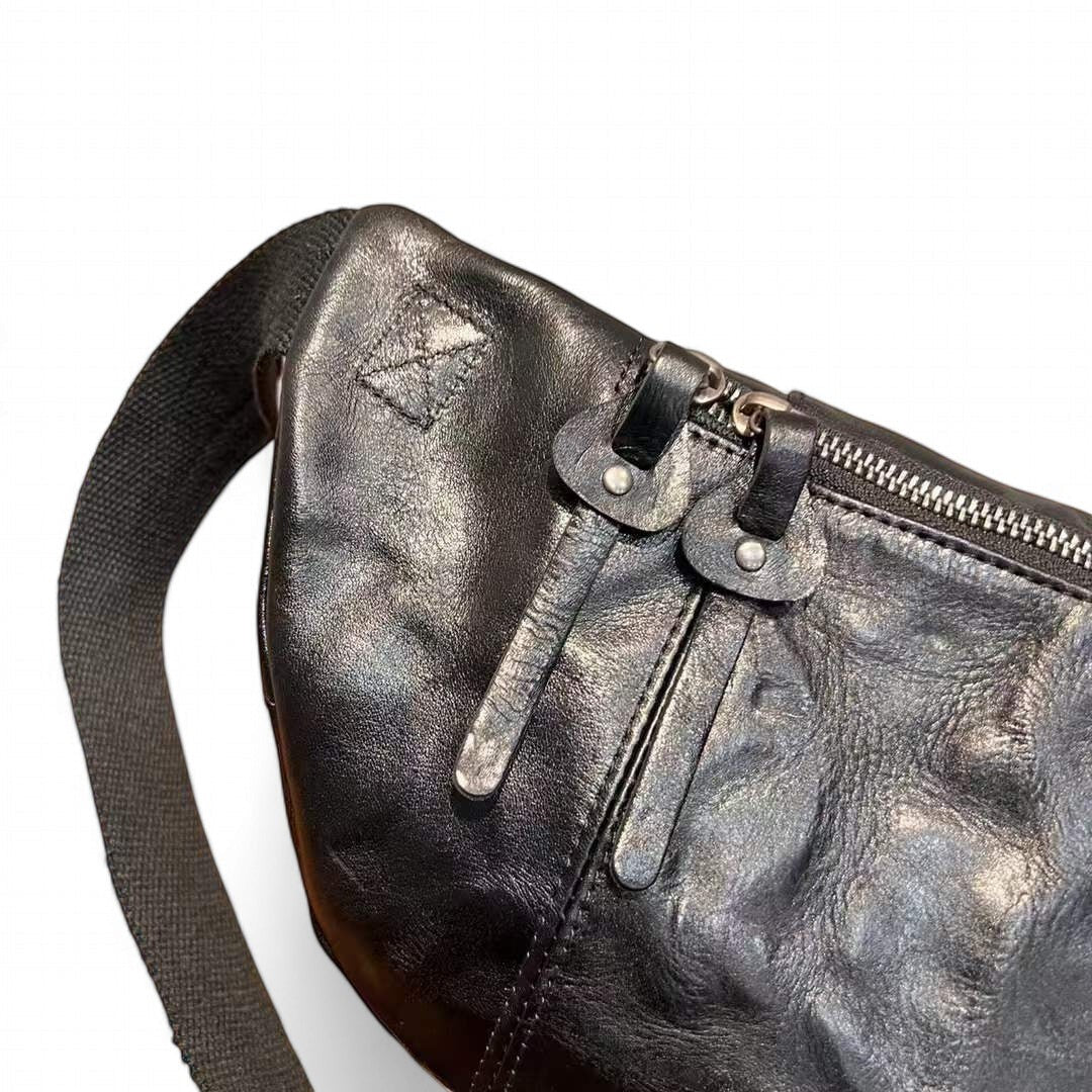 Barcon Getta Inc AXUMAWIT black full grain leather fanny bag with multiple zipper pockets and adjustable strap.