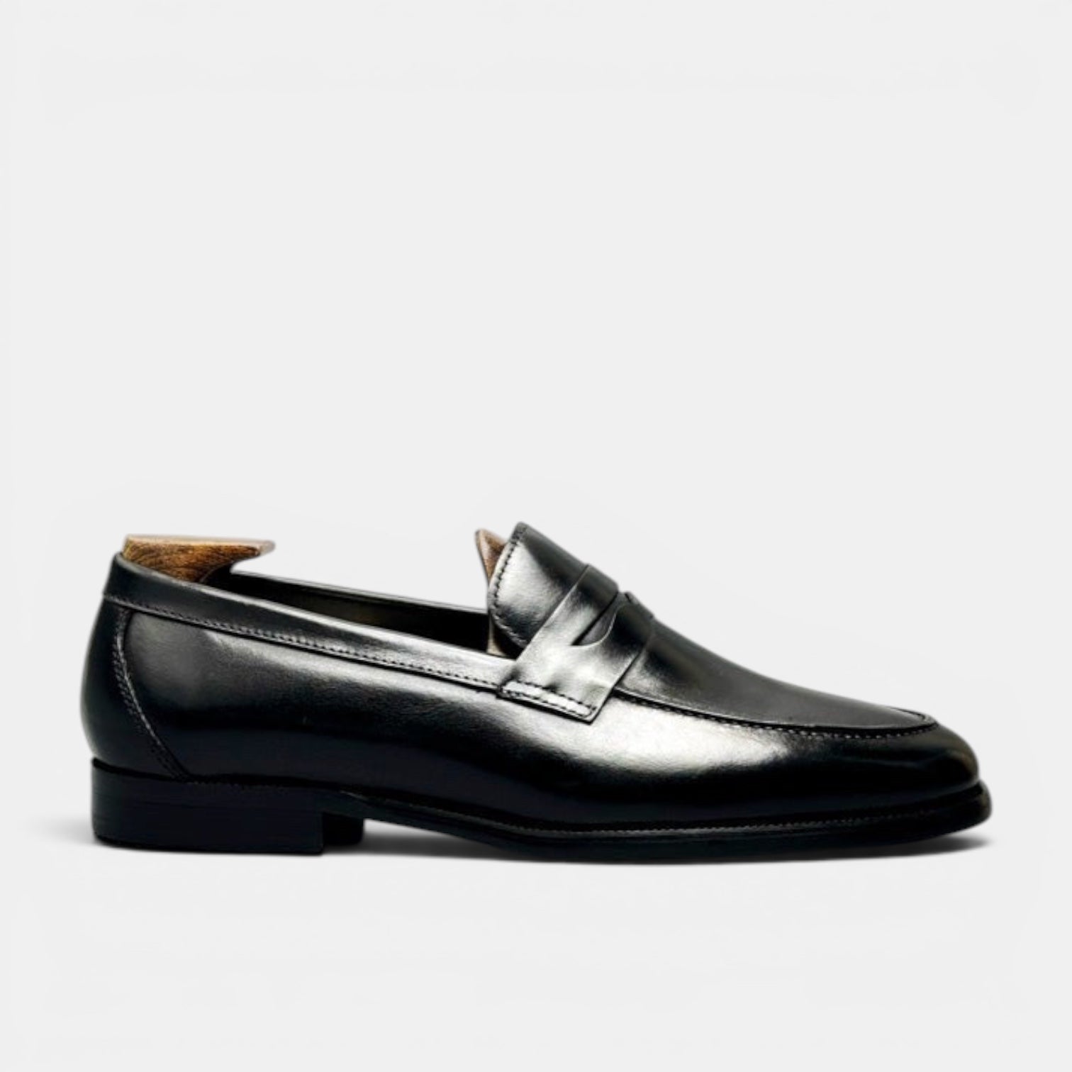 Barcon Getta Inc BANGUI black polished leather penny loafers with strap detail.
