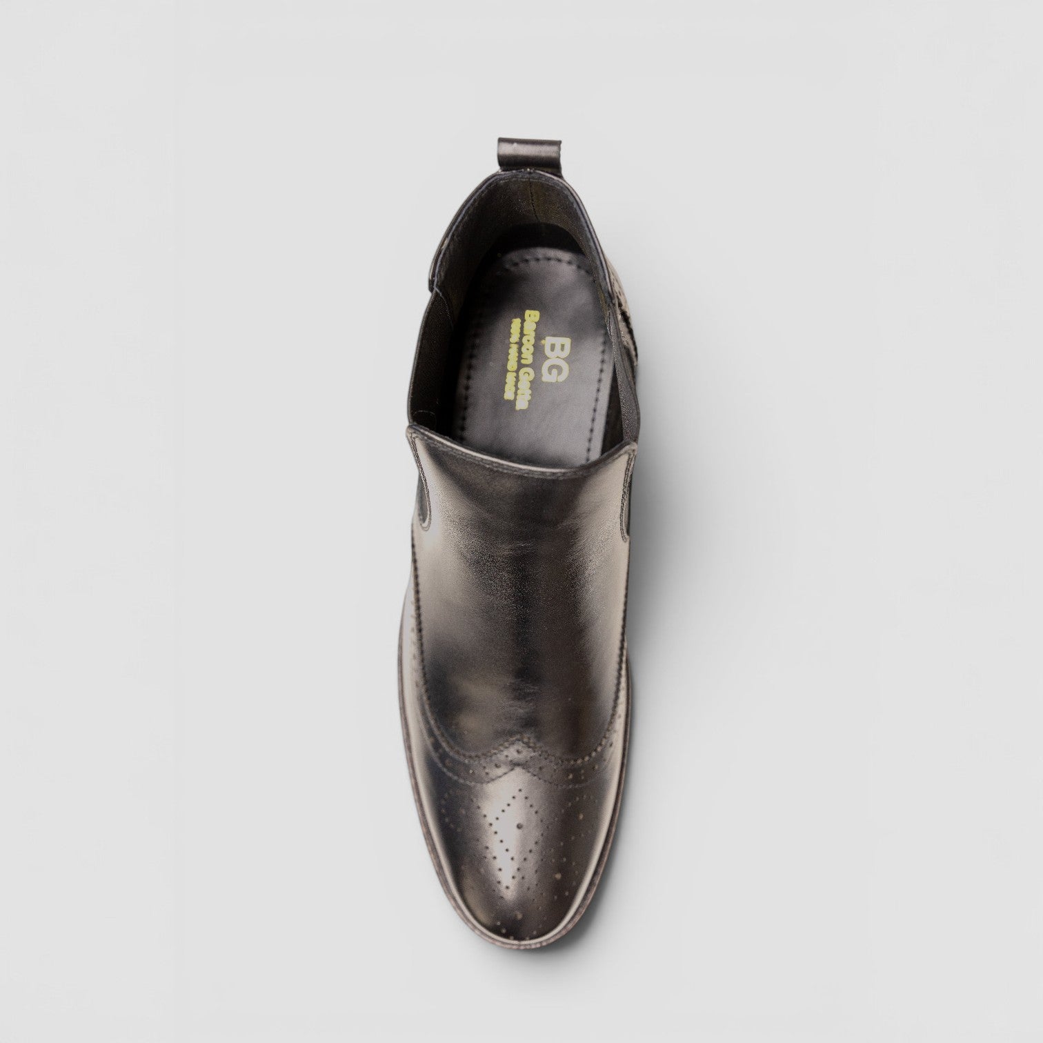 Barcon Getta Inc black leather wingtip Chelsea boots with brogue perforations and elasticated side panels.