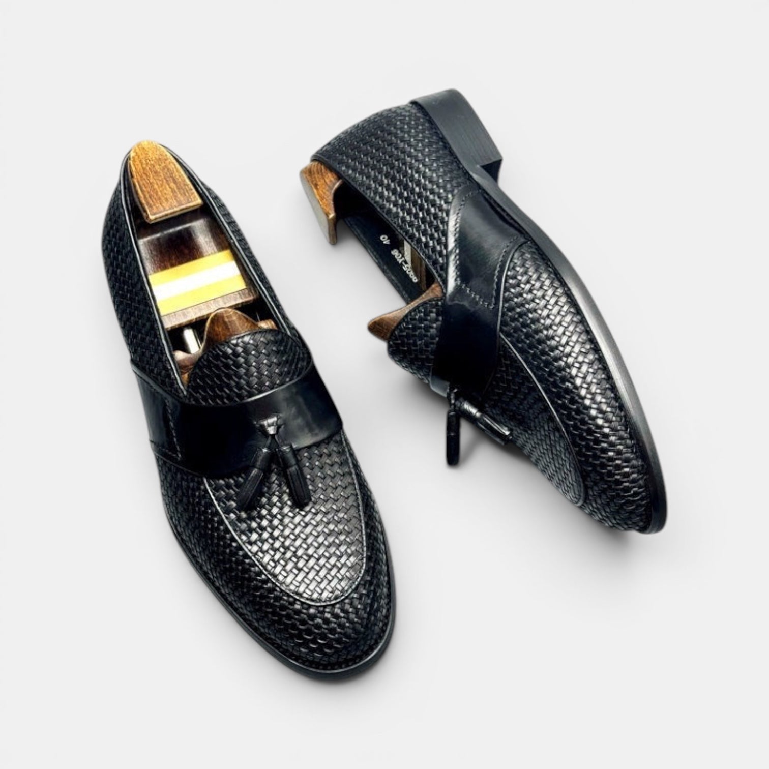 Barcon Getta Inc black woven leather tassel loafers with smooth leather strap and classic tassel detail.