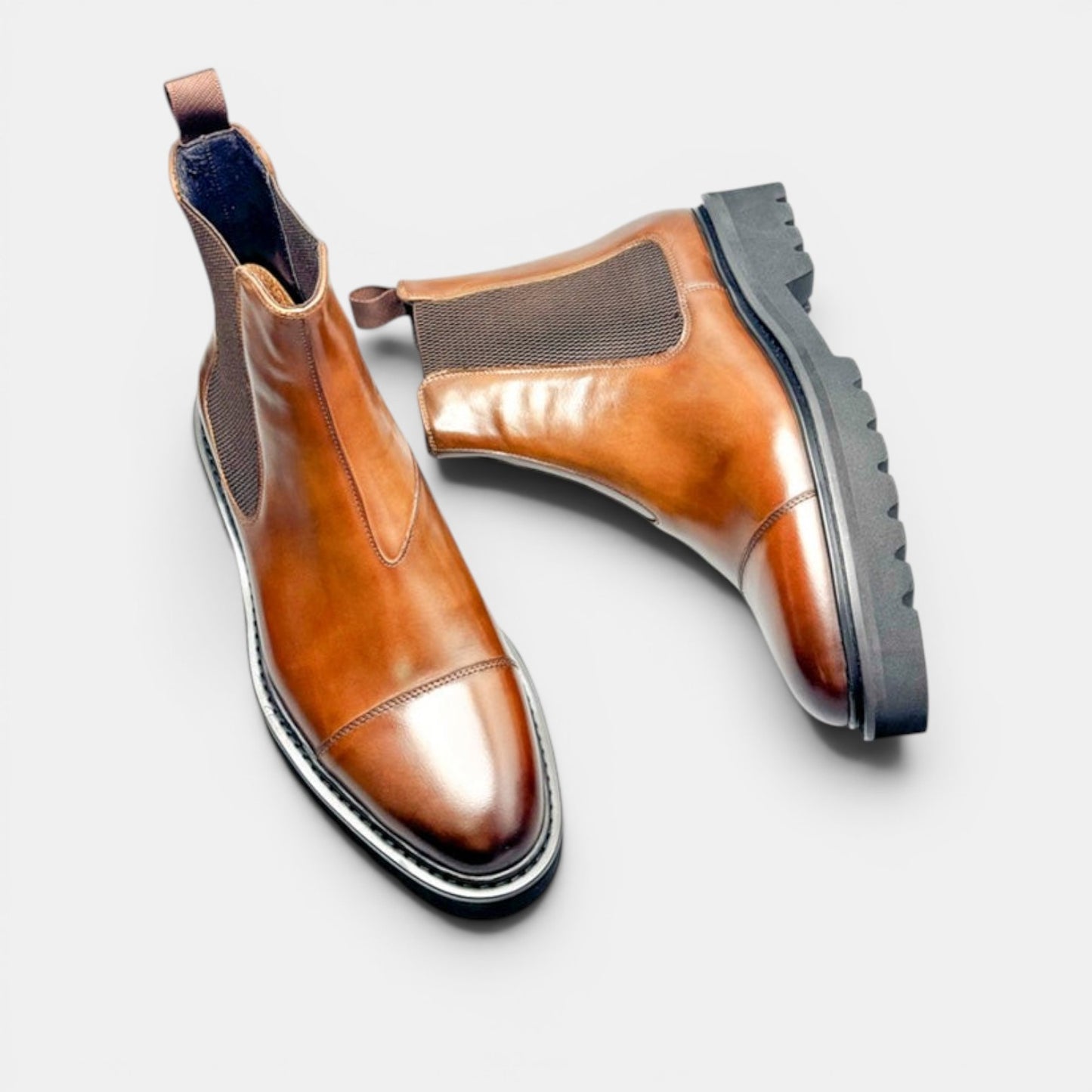 Barcon Getta Inc brown leather Chelsea boots with elastic side panels and lug sole. Cap toe detail.