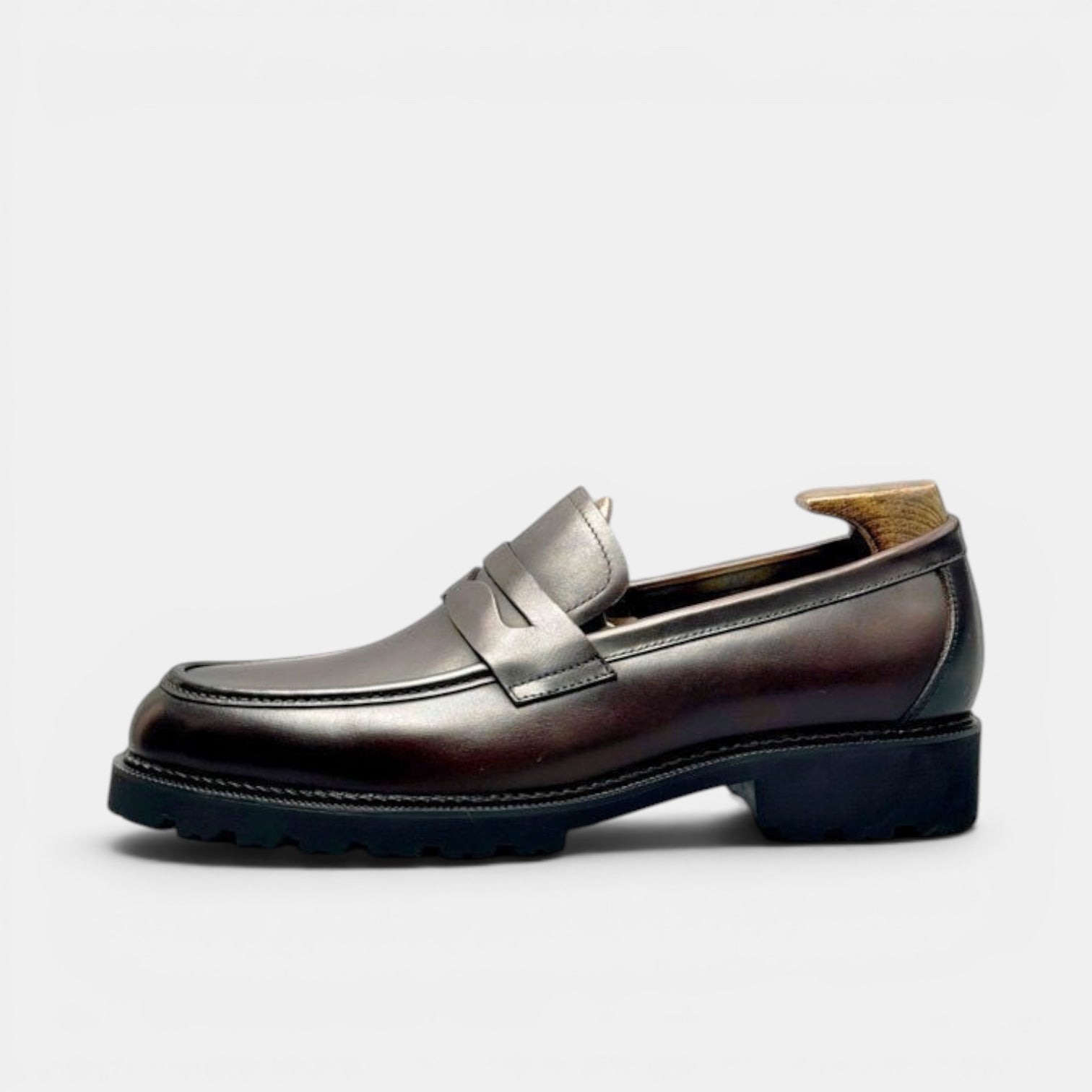 Barcon Getta Inc NIAMEY Penny Loafer in polished black leather with a lug sole. Classic design with a modern silhouette.