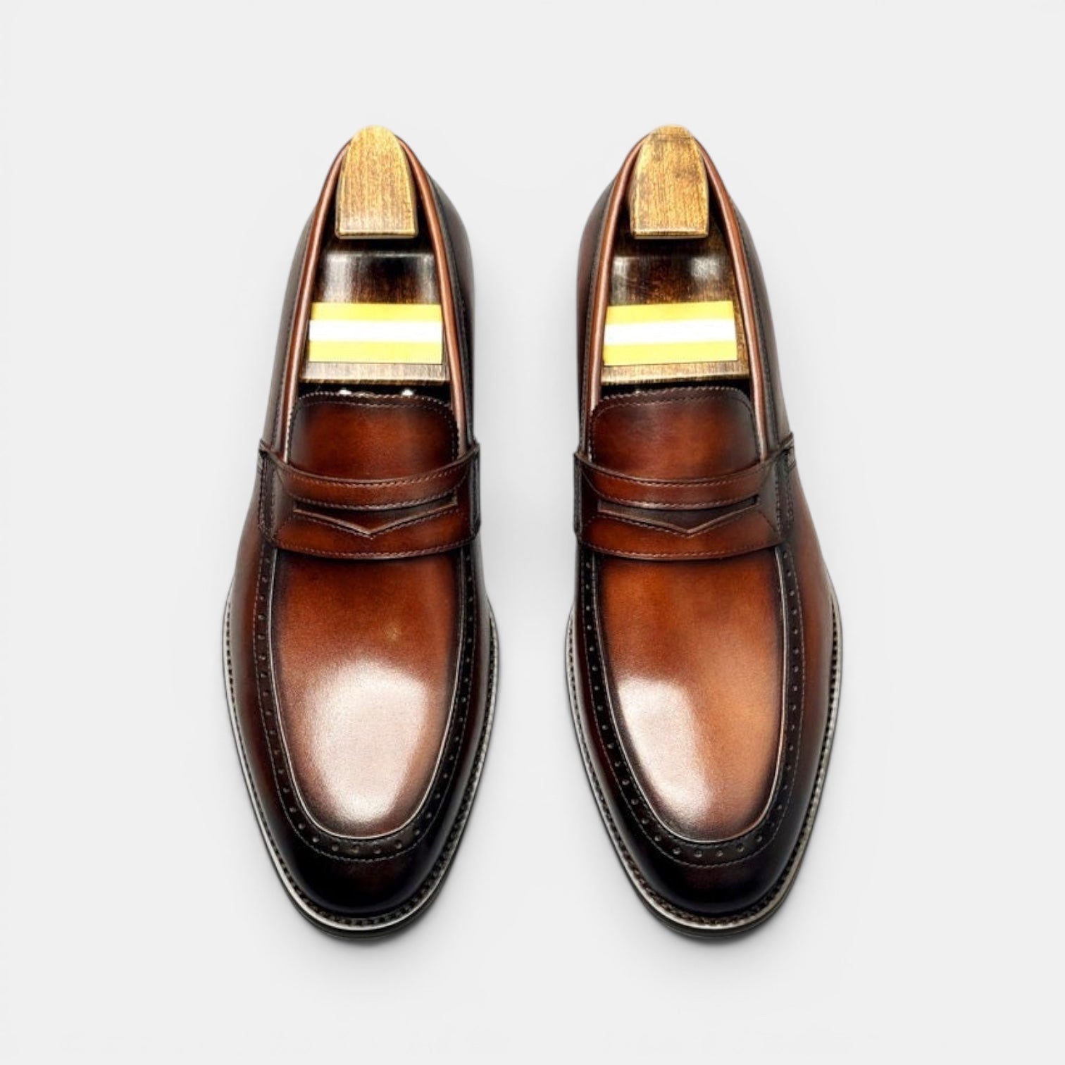 Barcon Getta Inc KINSHASA men's brown leather penny loafers with wingtip detailing and polished finish.